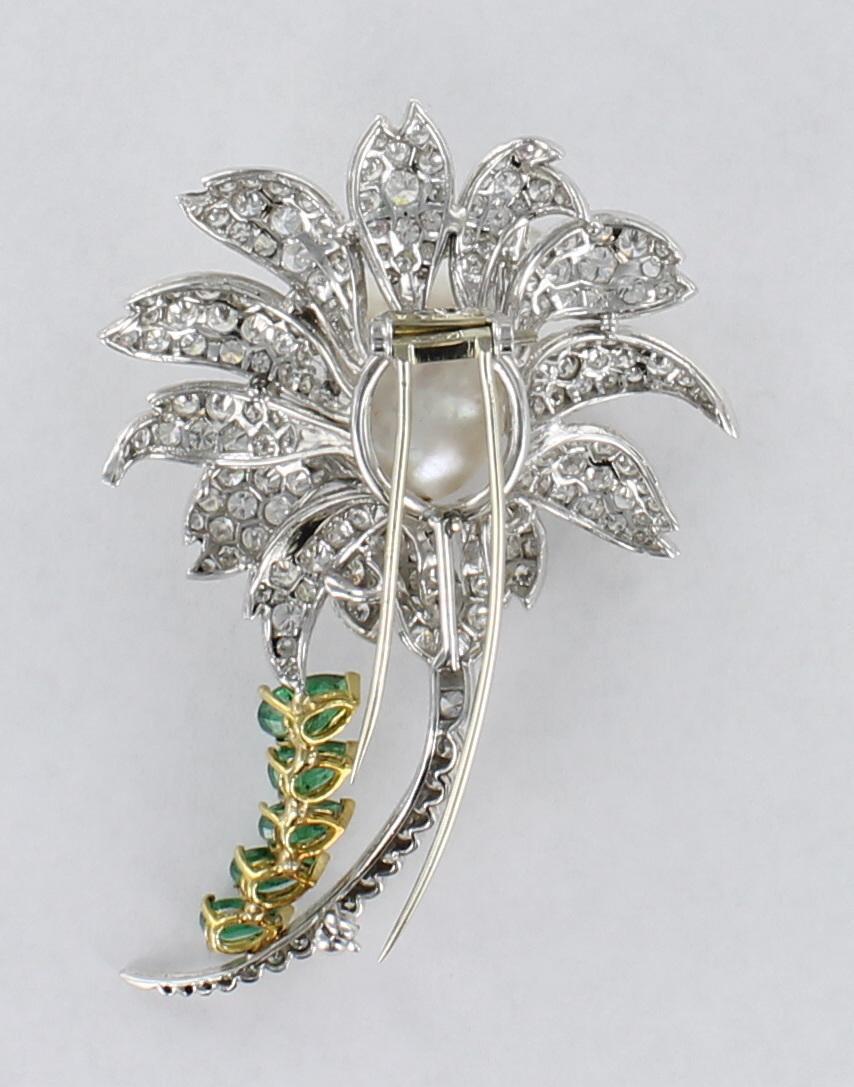 This platinum and 18 karat pin will be impossible to ignore on your dress or jacket. The beauty of baroque pearls is showcased in the center of the pin, and it sits amidst beautifully-rendered diamond petals finished with a diamond stem.