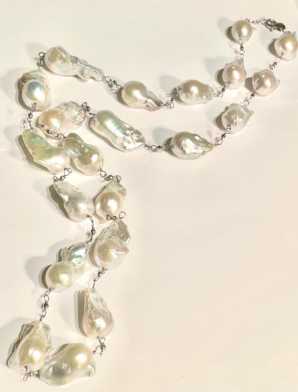 Description
Large white high-luster baroque freshwater pearls 23mm to 39mm, 14k white gold. Can be doubled.
Item # N3367

Materials and Weight
Freshwater Baroque pearls (21 pieces), 23 to 29 mm
14k white gold 3mm faceted balls.
14k white gold with