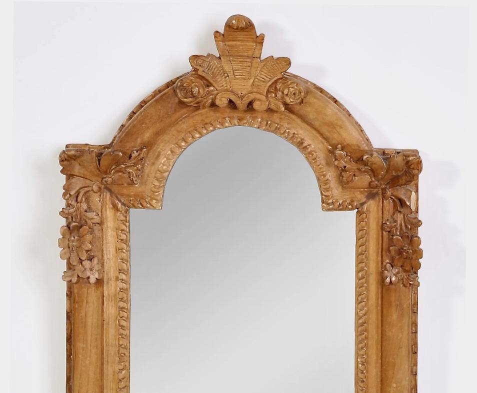 This is a great example of a Baroque Style (c. 1800-1820) small carved walnut bridal mirror. The original gold leaf has been stripped down to the frame's natural carved walnut, which has acquired its own natural patina. The floral carved elements