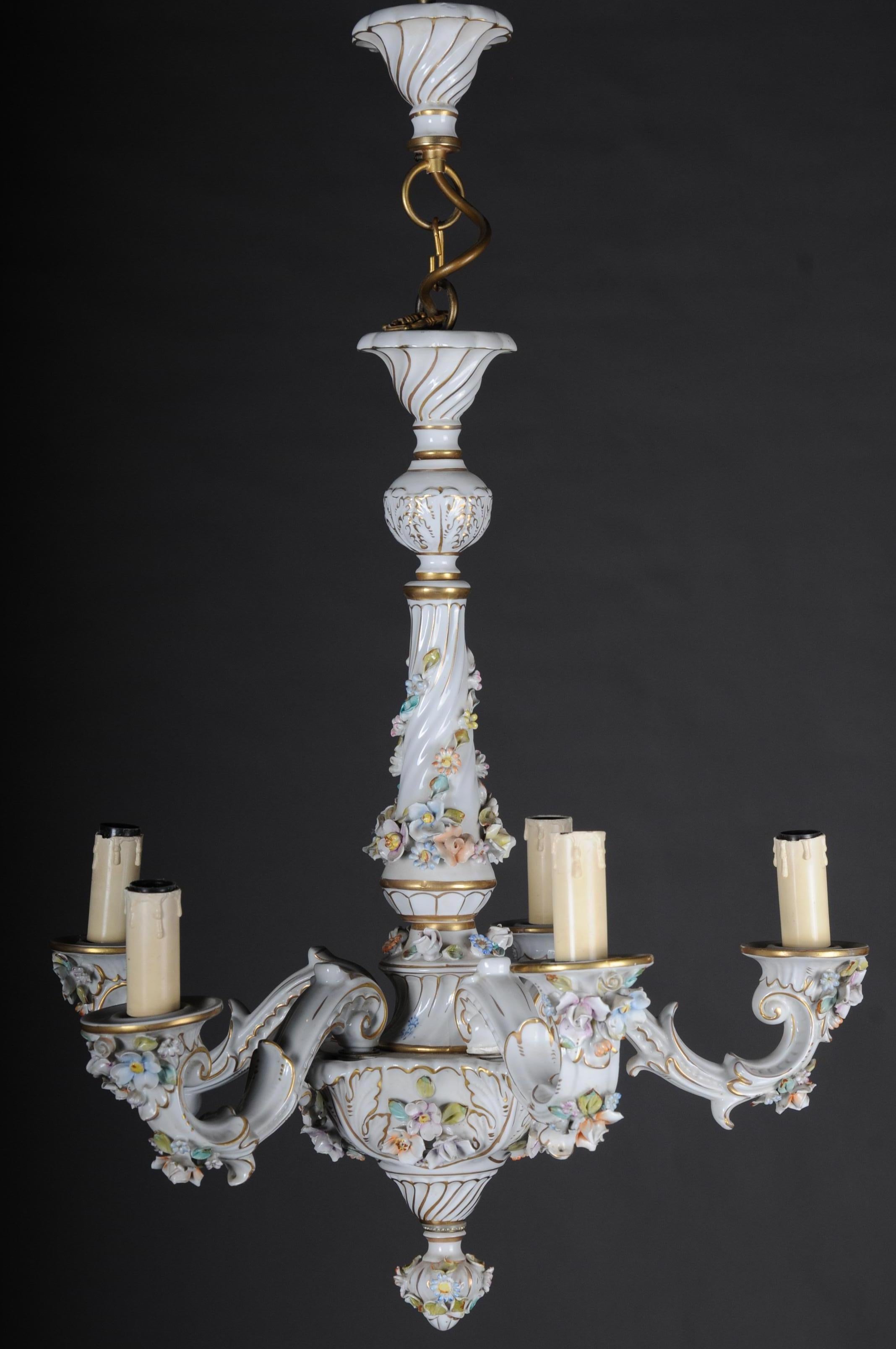 Baroque porcelain chandelier / candelabra old second half of the 20th century

Rich painted porcelain frame. Multiple curly arms. High, decorated shaft with 5 externally placed flames. Electrified. Candle-shaped pods.
 
(F-89).