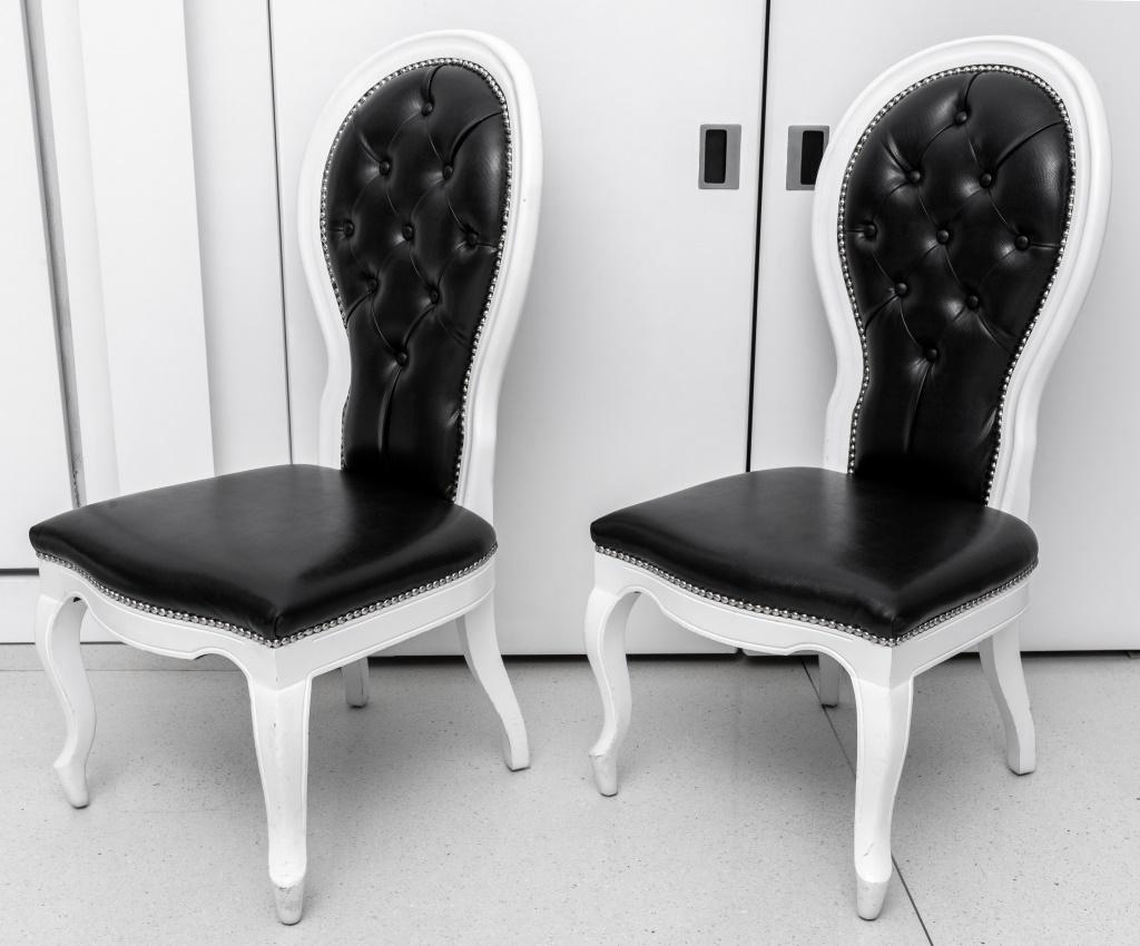 Pair of Baroque Revival black and white side chairs, with tufted faux snakeskin black upholstery surrounded by a decorative studded trim, with a white lacquer base, on four cabriole legs, unmarked. 43.5