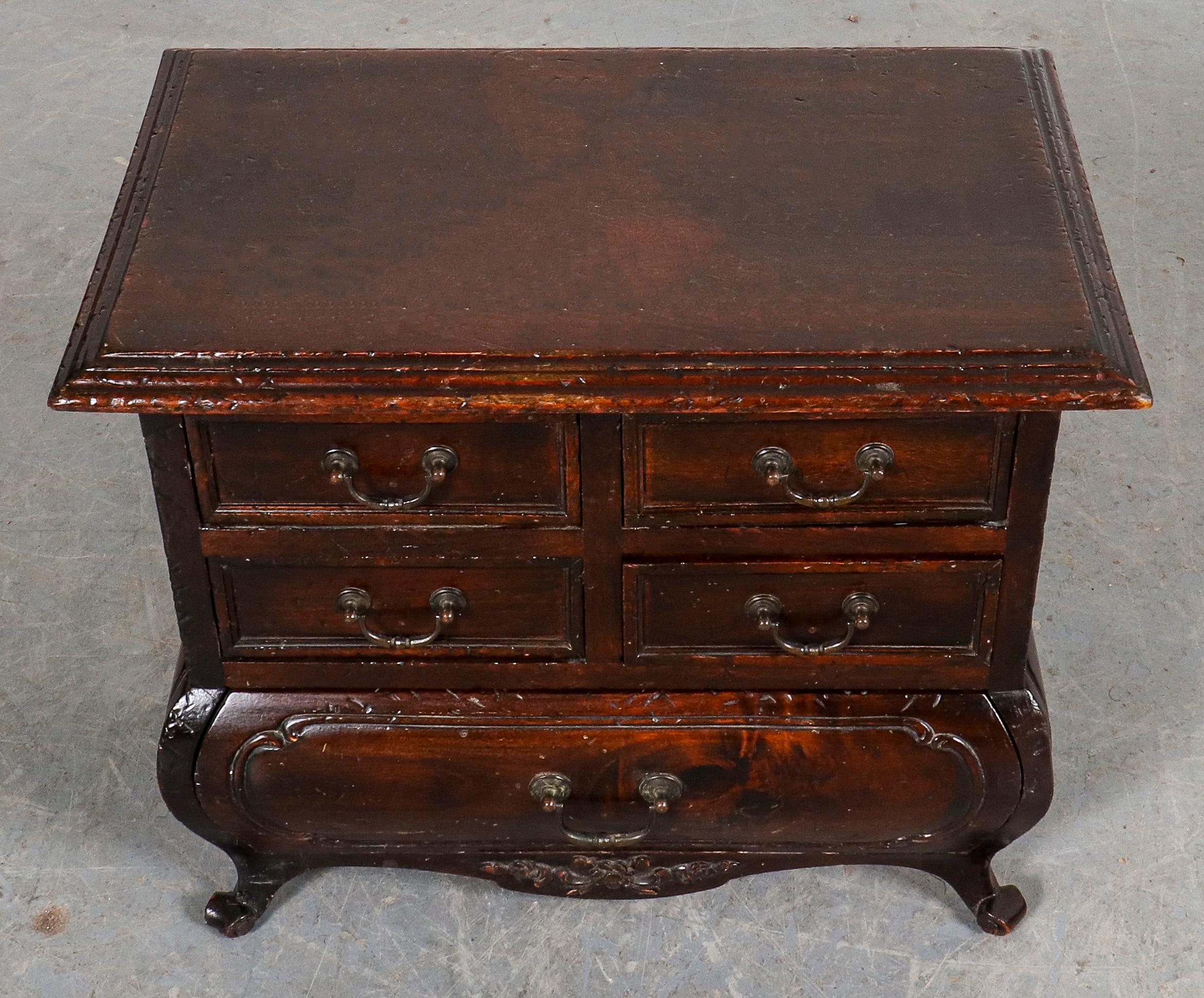 Baroque Revival diminutive chest of drawers with two rows of double drawers over a bombe single drawer. 16.25