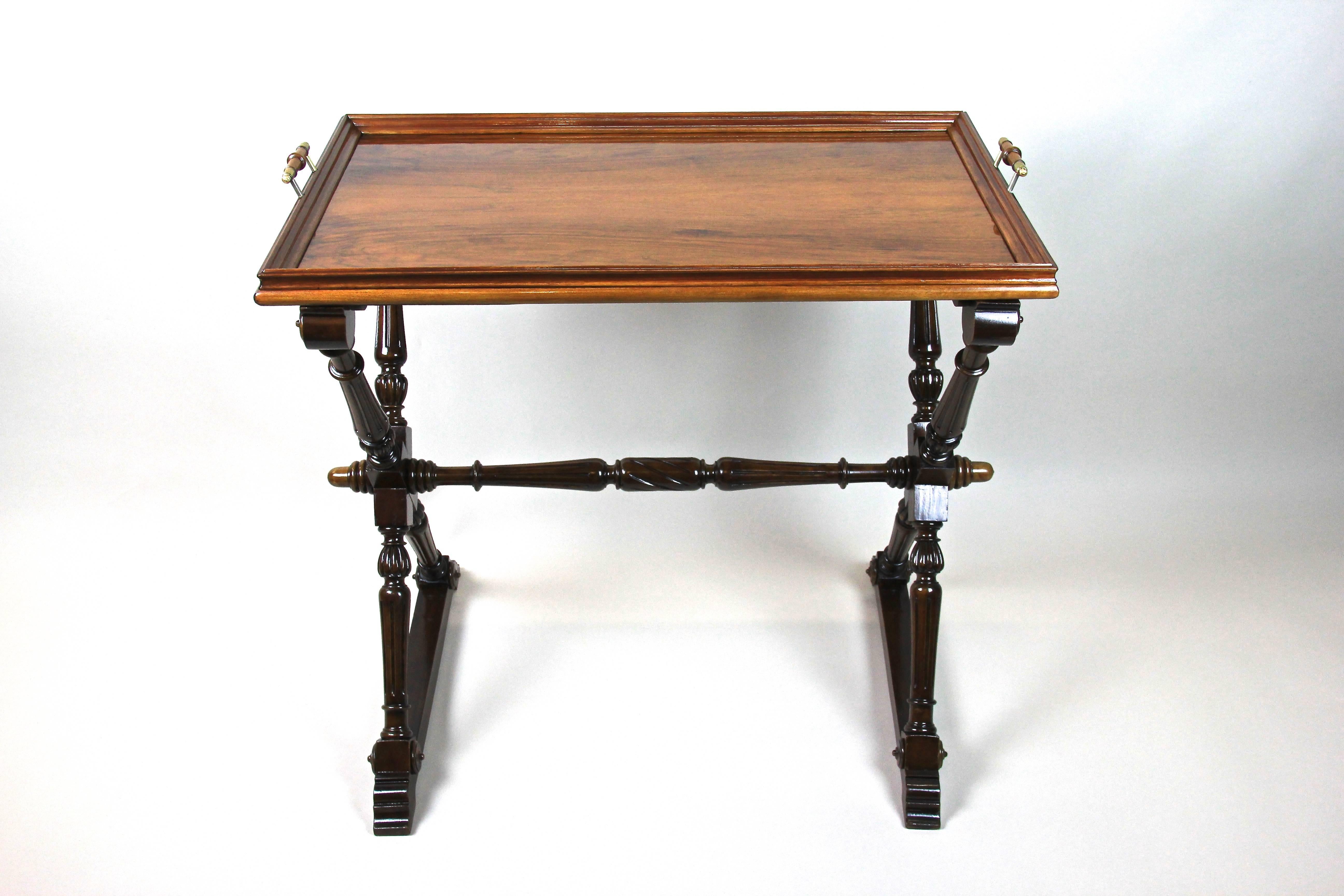 Beautiful Baroque Revival table with removable tray from Austria, late 19th century, circa 1870. Made of solid walnut this artfully hand carved piece shows great designed legs and comes with a nice highlight - a removable tray tabletop veneered in