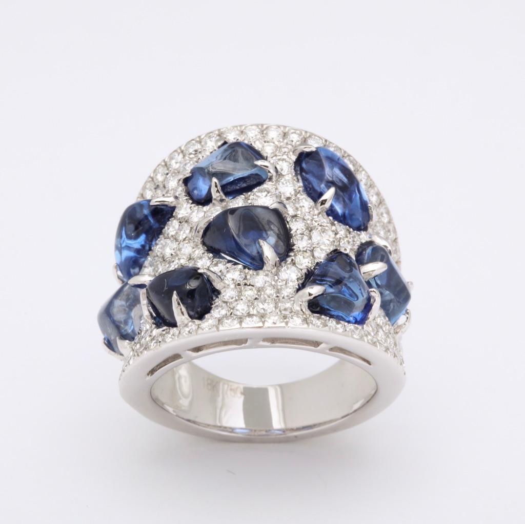 Baroque shaped cabochon sapphires are individually set into the wide diamond ring.  One of a kind and to be enjoyed!
Sapphires: app. 10 carats
Diamonds: app 2 1/2 carats

Complimentary overnight delivery by Federal Express is always included as well