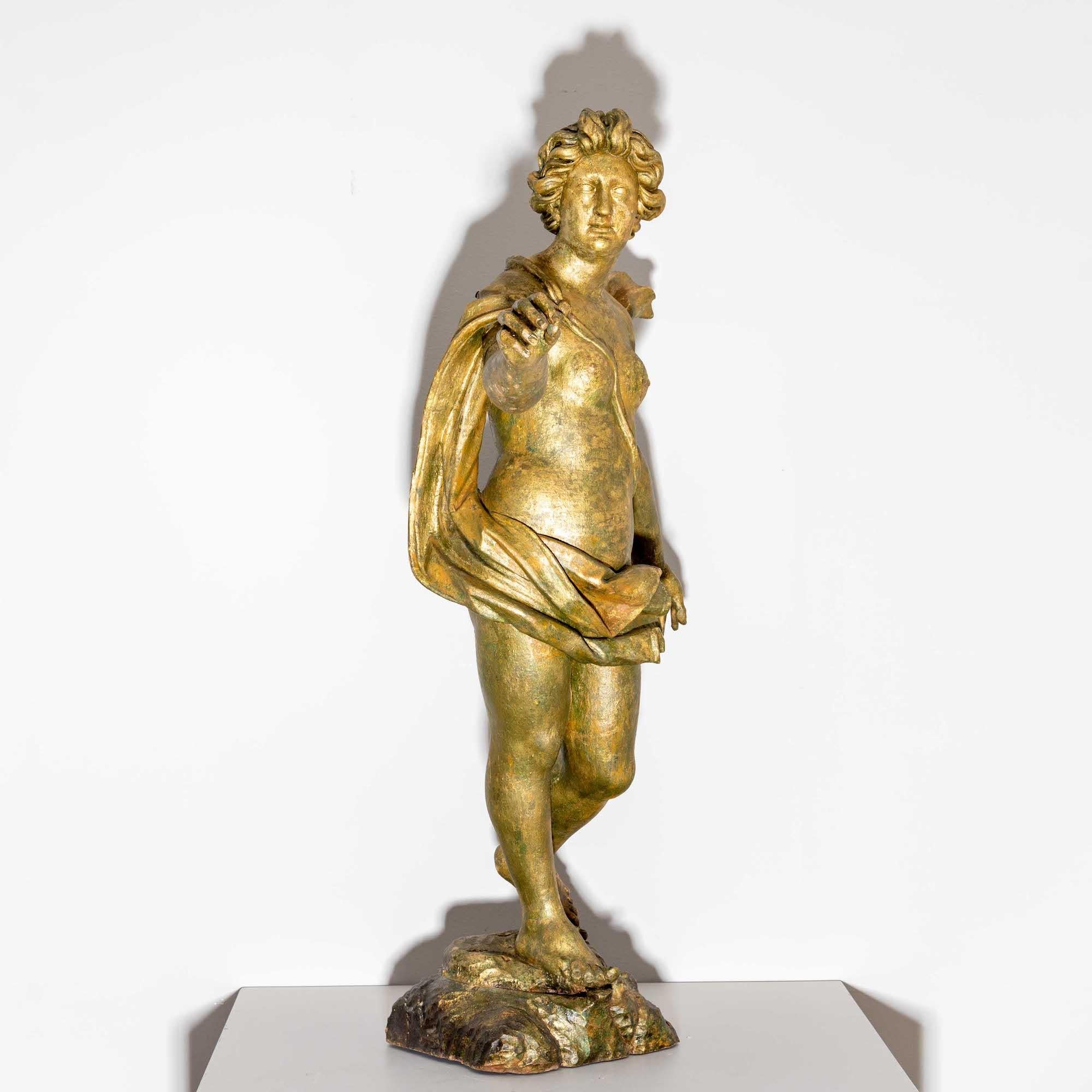 Patinated baroque sculpture on a stylised landscape base in the form of a female figure with a flowing cloak and an expansive gesture. Provenance: Wittelsbach estate.