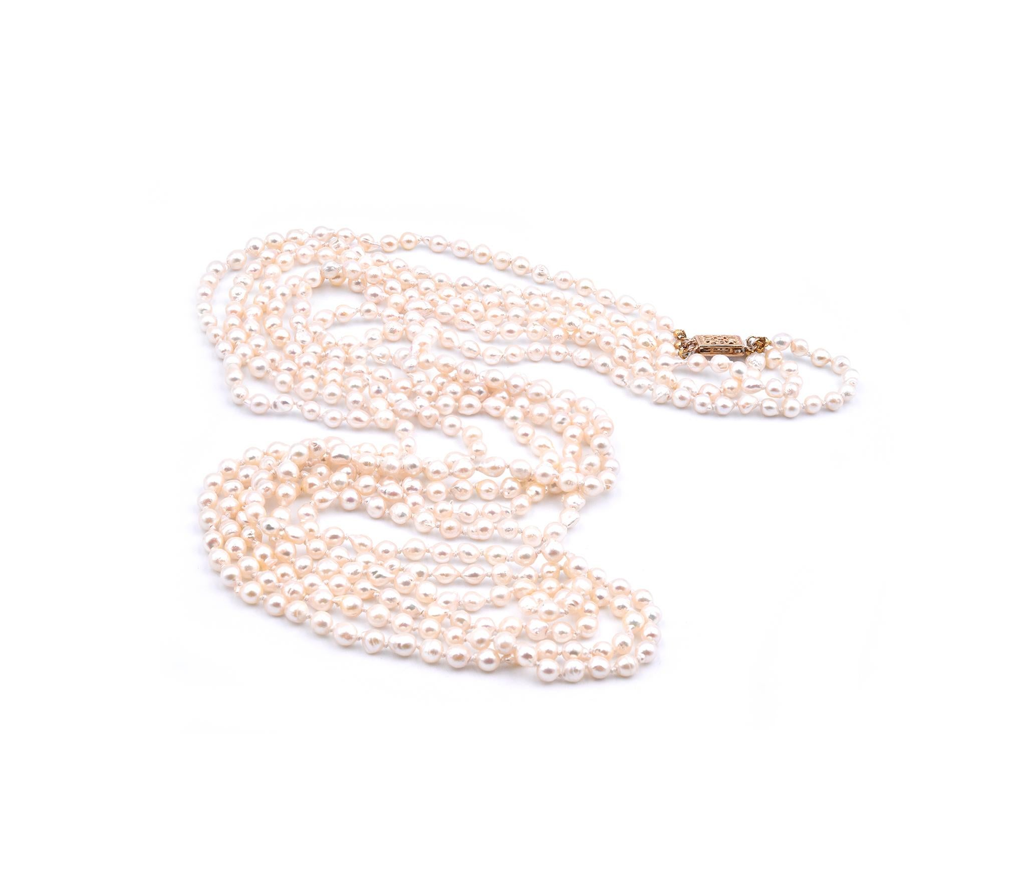 Designer: Custom
Material: 14K yellow gold clasp
Pearl: 4.5mm baroque seed pearls
Dimensions: necklace measures 32-inches in length
Weight: 47.75 grams
