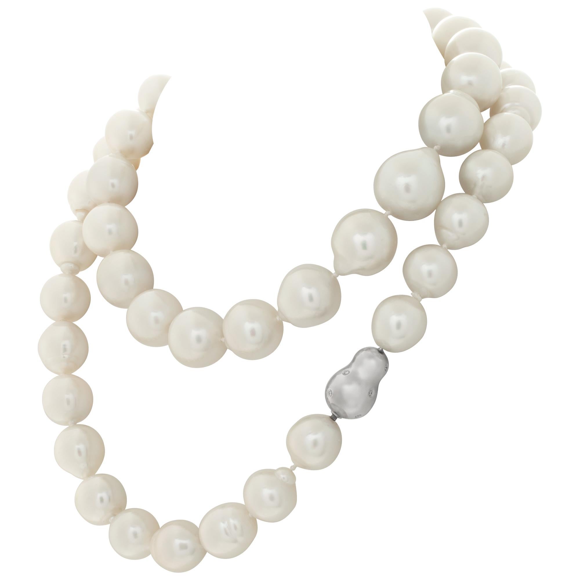 Baroque South Sea Pearl sautoir necklace with 18k White Gold & Diamonds Clasp. Baroque South Sea pearl graduated from 18 to 14mm. Silver/ pink overtone hues. Opera length: 34 inches.