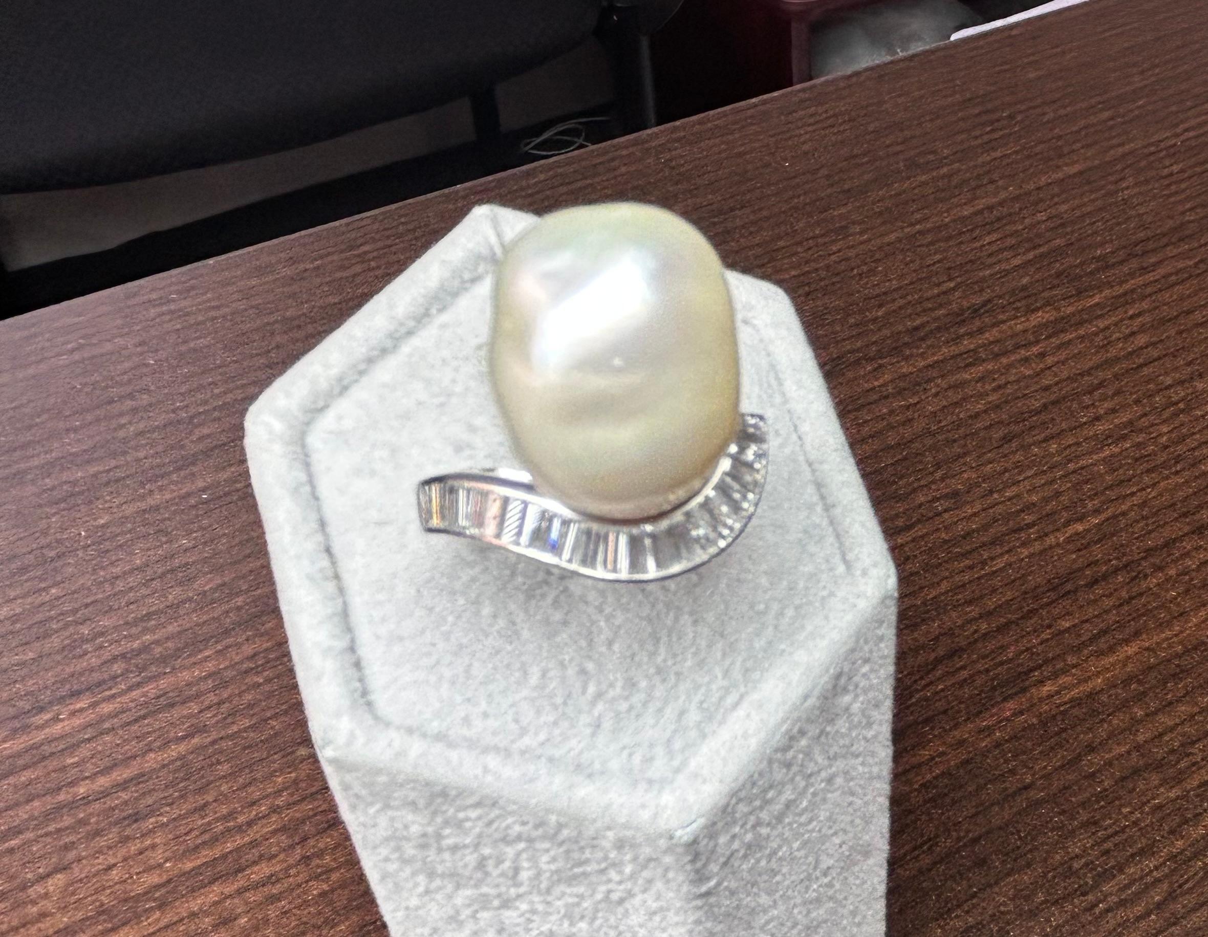 Amazing Estate Statement Platinum ring set with a Baroque South Sea Pearl, measuring 16 x 13 x 11 MM.  Unique Size and Shape of the Pearl make this ring special.
The Pearl is surrounded by Tapered Baguette Cut Diamonds having a Total Weight of 1.00