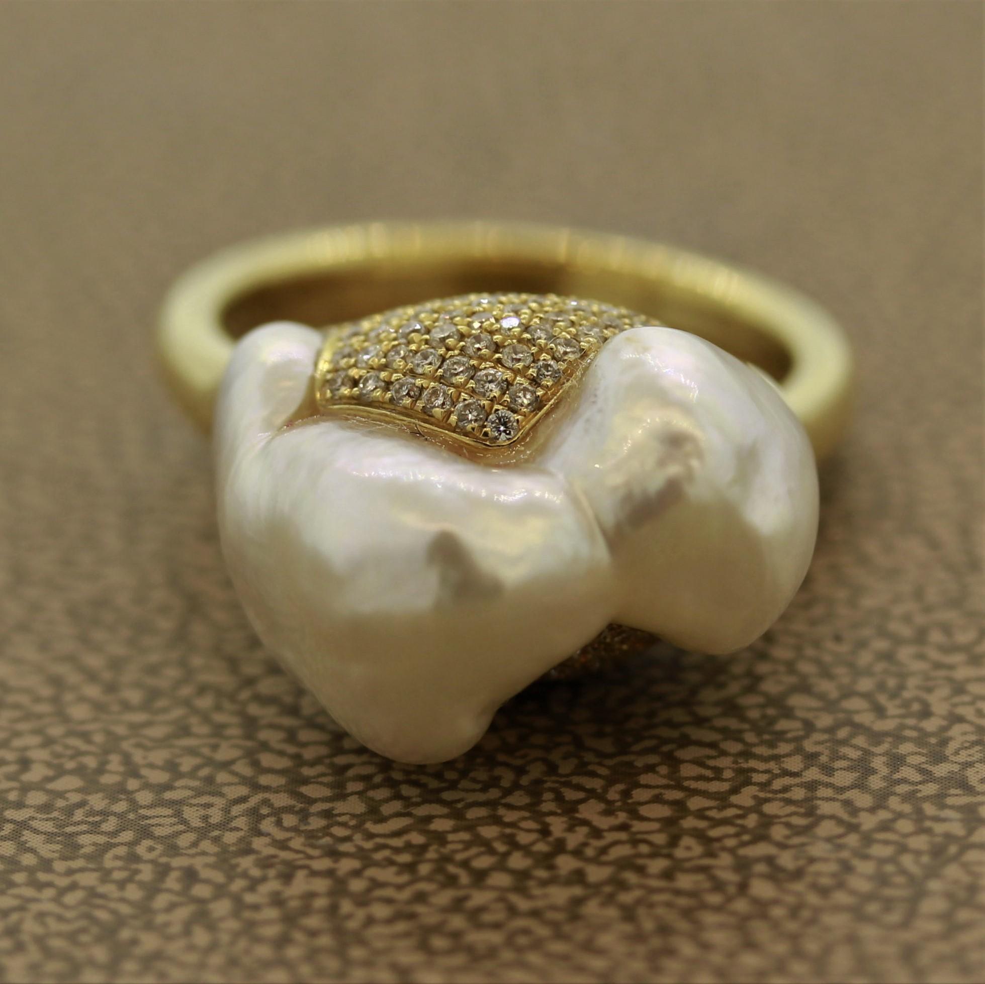 A pearl mountain! This modern designed ring features a baroque South Sea pearl which has grown in the shape of a cascading mountain. It is accented by 0.50 carats of round brilliant cut diamonds set on the base of the pearl mountain. Made in 18k