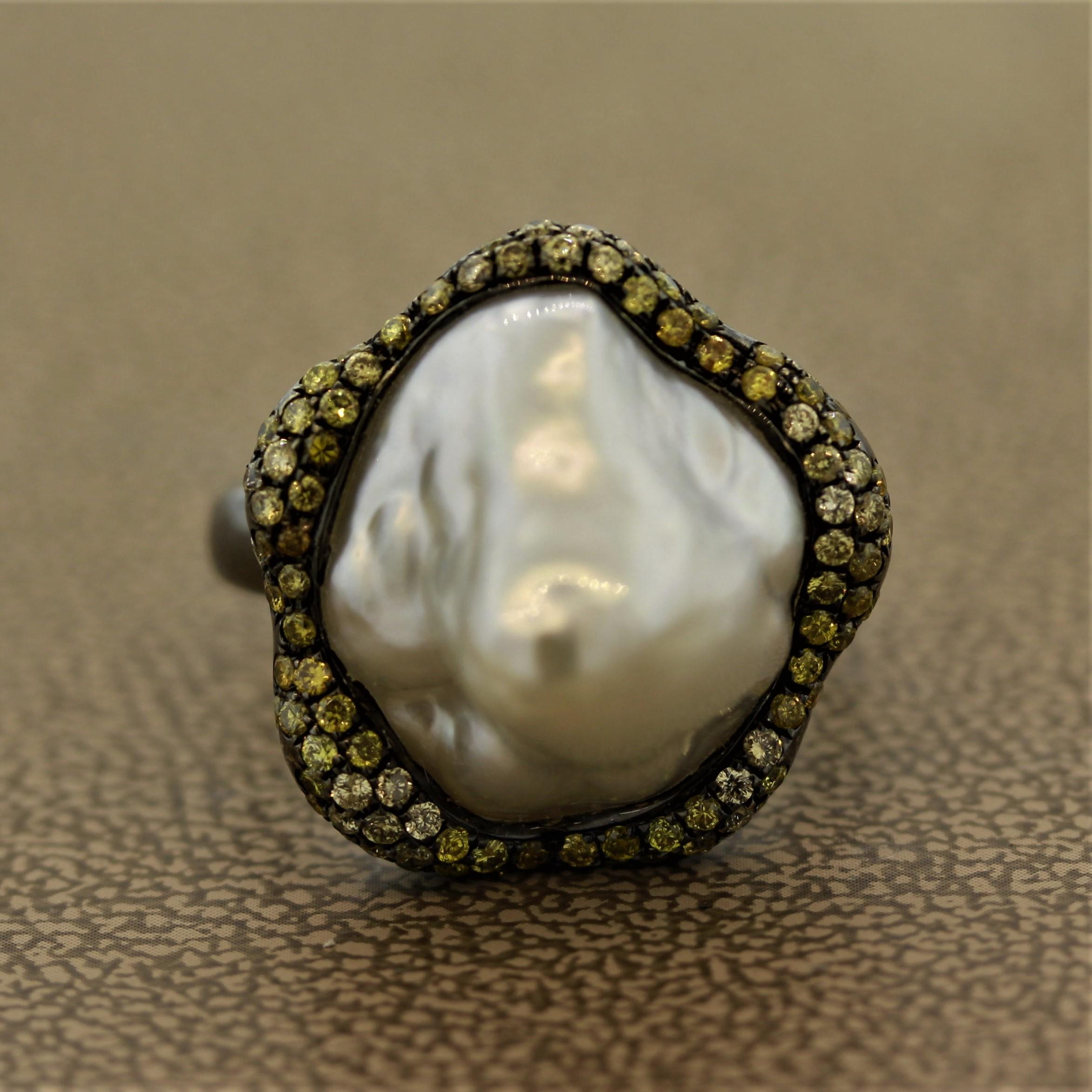 A truly one of a kind and rare Baroque South Sea pearl that is a must-have especially for those who have a unique and vibrant personality.

Adding sparkle to the ring are 0.76 carats of fancy yellow round brilliant cut diamonds.

The ring is made of