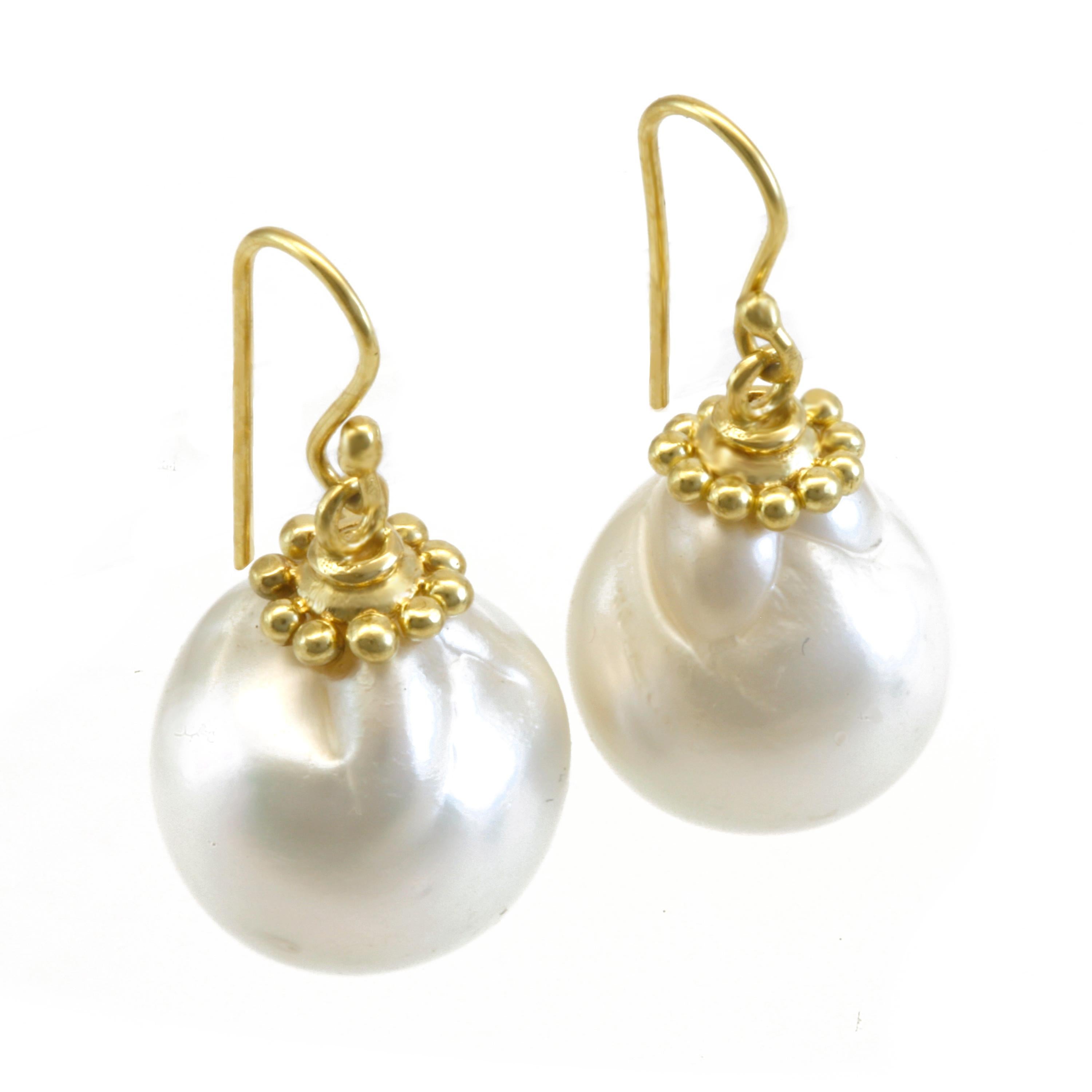    These Plump, Creamy White Pearls are from the warm oceans of Tahiti and  Measure 15mm-17mm. Hanging from elaborately soldered and fabricated solid 18k caps and wires, these Ocean Gems catch the eye with each movement of the head. French wire