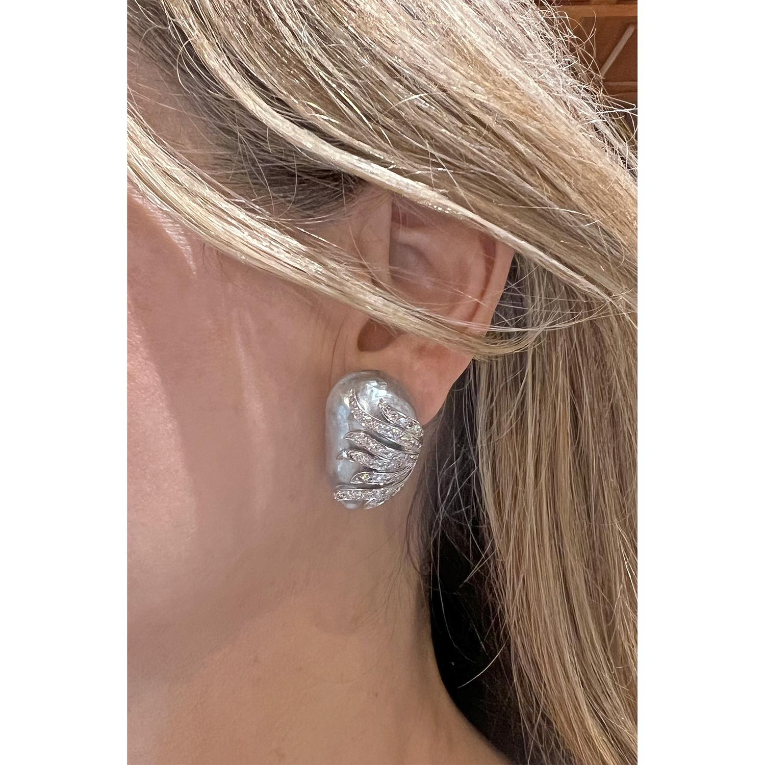 Large baroque South Sea cultured pearl and diamond earrings, featuring a bluish-gray South Sea baroque pearl set in an 18k white gold mounting and a cream-toned white South Sea baroque pearl set in an gray oxidized 18k white gold mounting.  Both