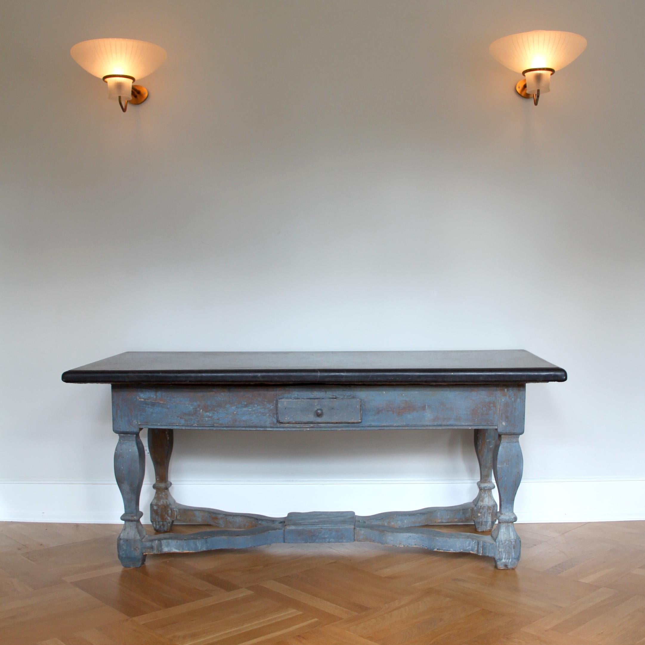 A large exceptional Scandinavian Baroque stone top table with profiled top of hand carved Komstad stone.

The lower part of of the table consists of painted oak and pinewood in subtle blue shades with baluster-shaped legs joined by X-shaped