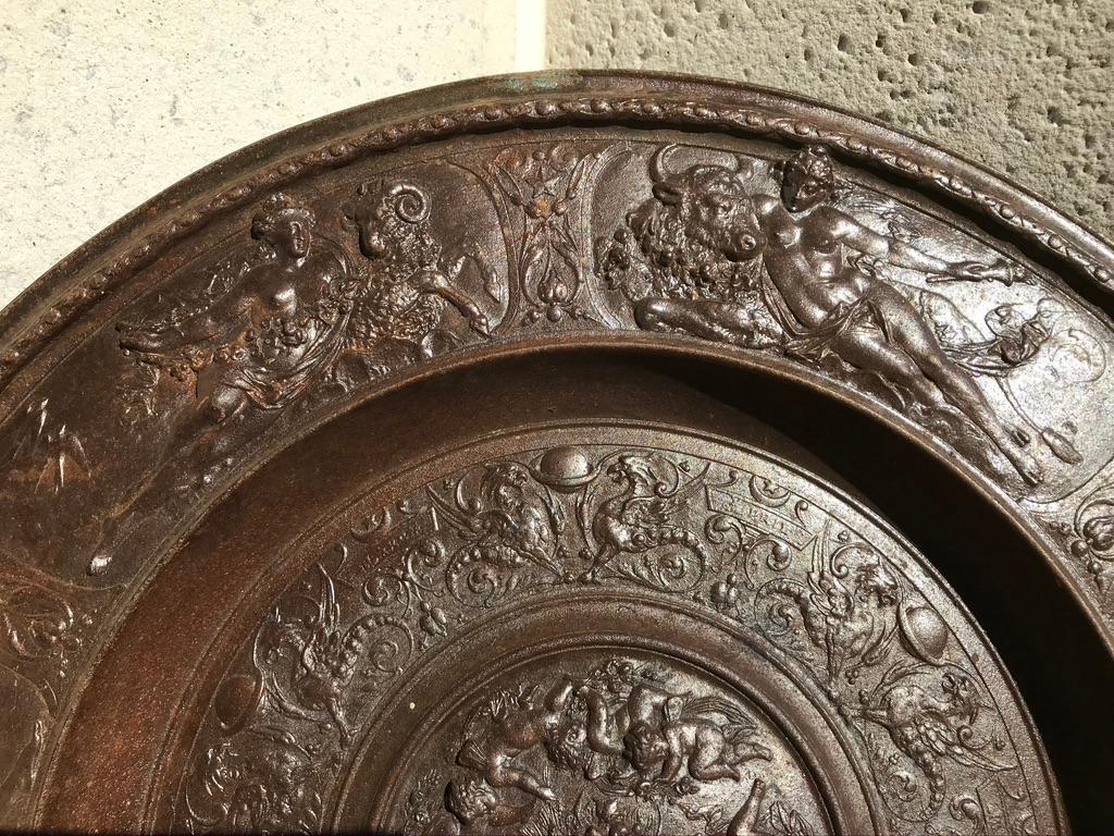 Large Berlin Iron Works cast iron charger with mythological figures of goddesses, putti, various animals and fish in relief. The central medallion with cartouches of the first six months of the year, January through June. The outer rim decorated