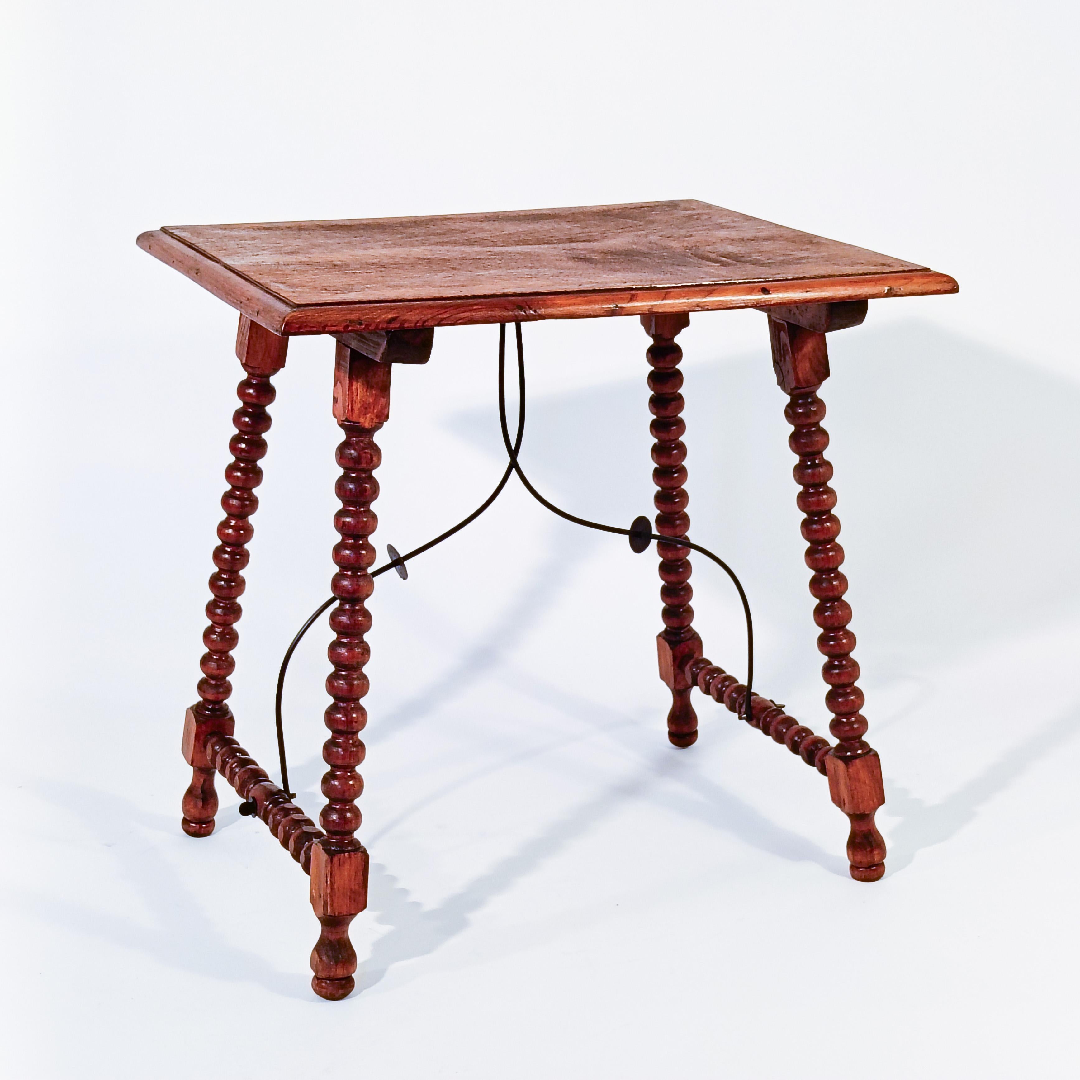 Kastilische Seite im Barockstil, Spanien, 30er Jahre. Vollständig aus handgeschnitztem und gedrechseltem Nussbaumholz gefertigt, mit einer Platte aus Schichtholz und schwarz lackierten Schmiedeeisendetails. Geölte Ausführung mit ökologischem Lack,