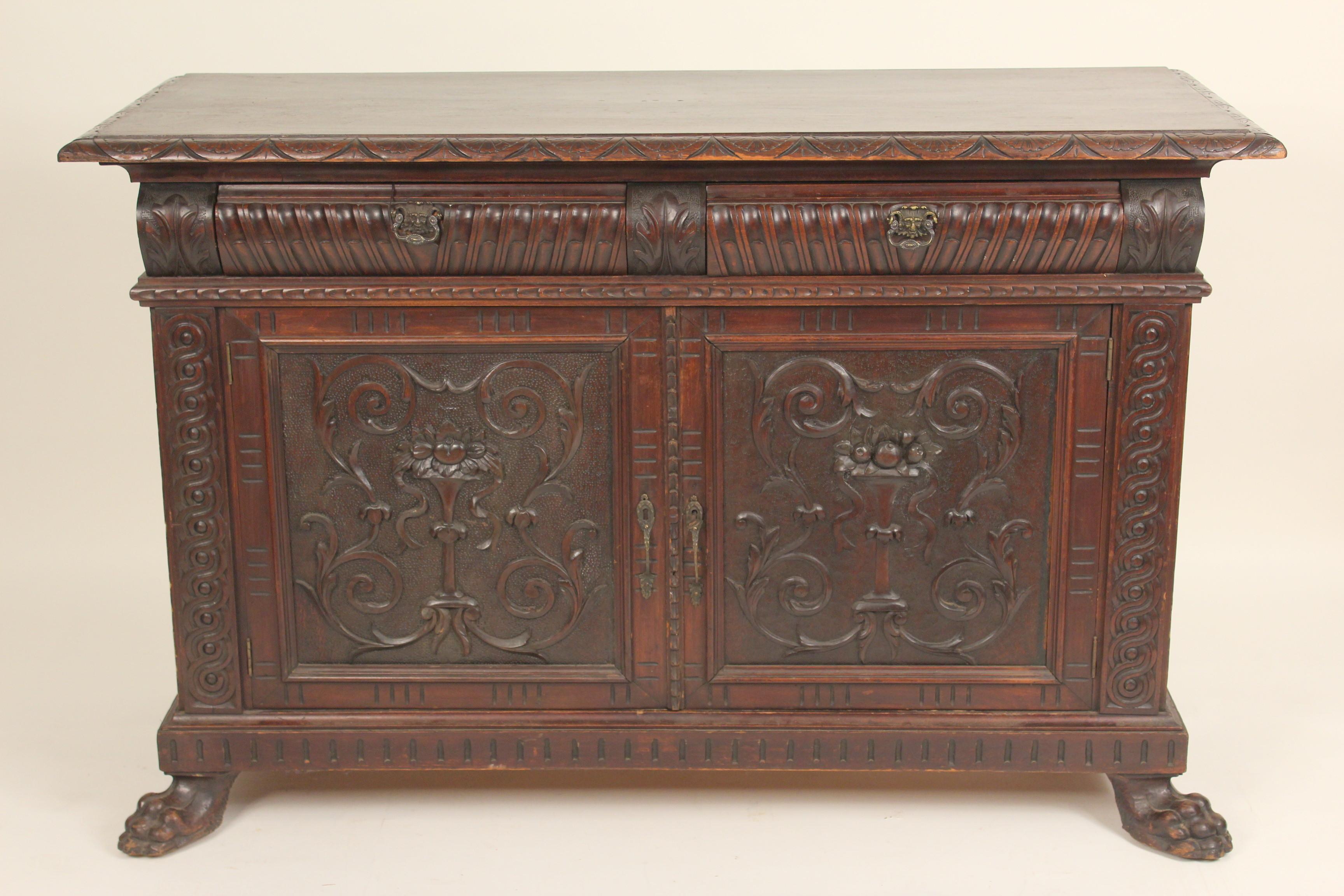 Continental Baroque style carved beech wood and walnut credenza with bronze drawer pulls, circa 1900.