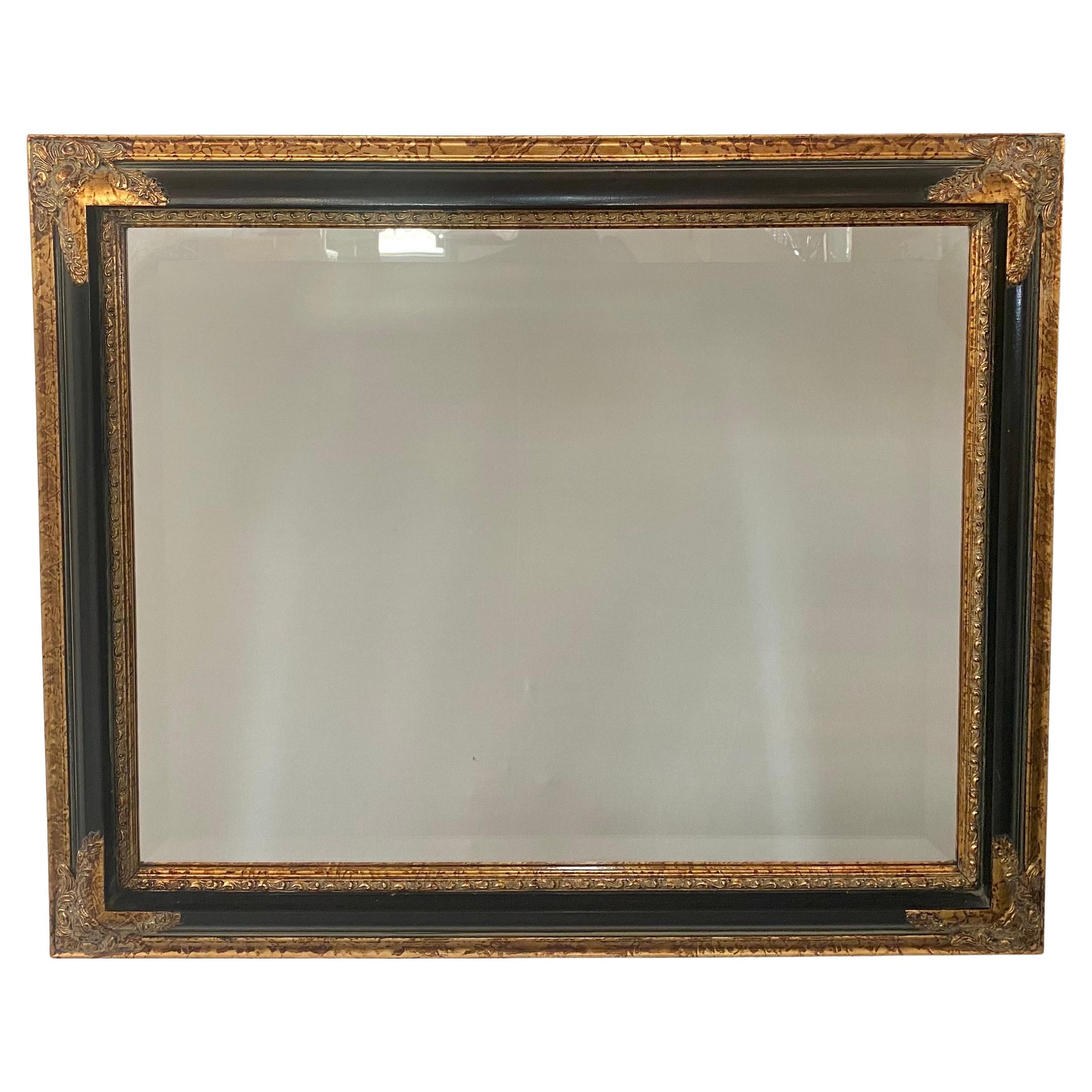 An elegant Baroque style rectangular mirror featuring a hand-carved frame made of ebony with a tortoise frame, an unusual mix which adds style to this classic design. The mirror corners and inner frame shows fine carved floral and leaves design in