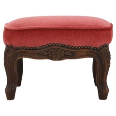 Baroque style foot stool in carved wood with coral velvet upholstery