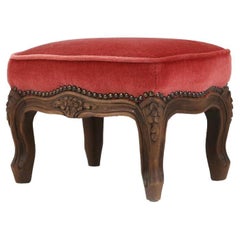 Baroque style foot stool in carved wood with coral velvet upholstery