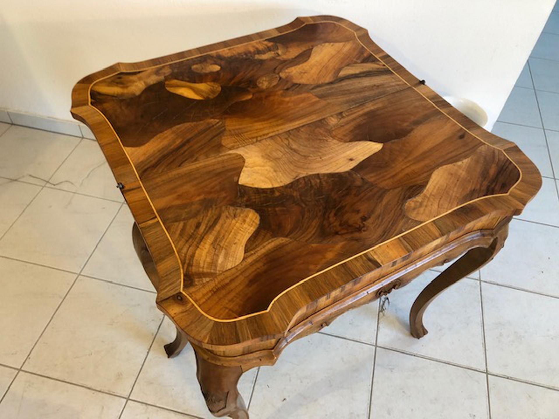 Elegant and petite baroque style console table or side table with a folding tabletop. This stunning walnut grain piece was made in the 1930s in the style of the baroque and is usable as a game table or folding table. It convinces with beautifully