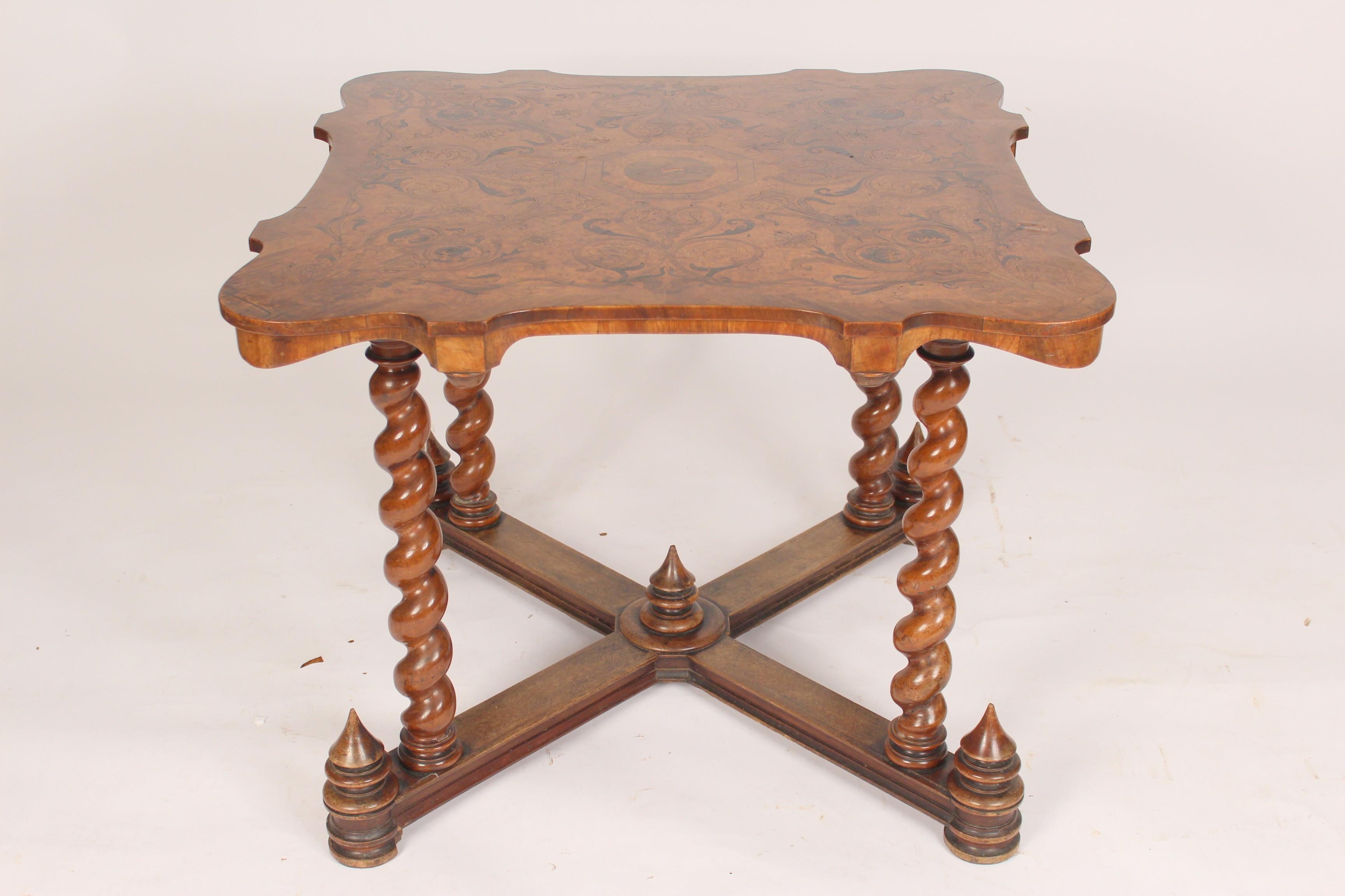 Baroque style games table with an inlaid burl ash top and barley twist legs, late 20th century. The knee clearance is 25