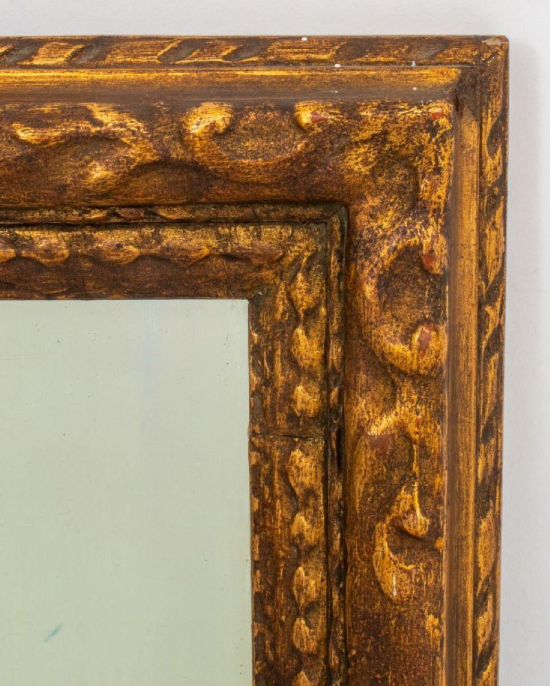 Baroque style giltwood frame mounted as a mirror, rectangular with floral moldings with running lozenge decoration centering an antiqued rectangular  mirror plate. Mirror: 30