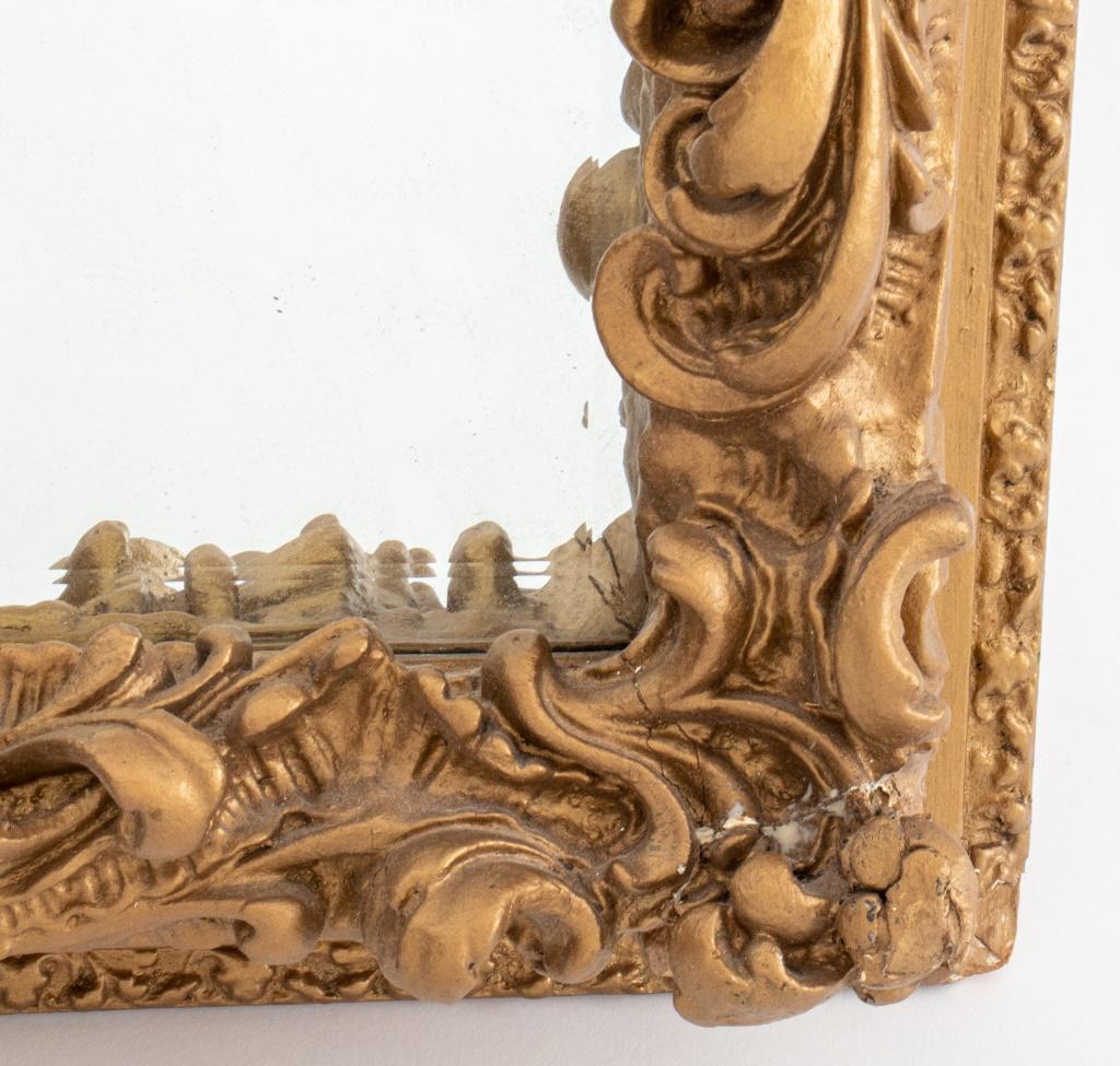 Baroque style gold painted plaster frame, mounted as mirror, the molded frame with border edge and interior rocailles, centering a mirror plate.

Dimensions: Mirror: 18.5