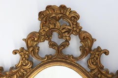 Baroque style oval wall mirror in gilded wood, France