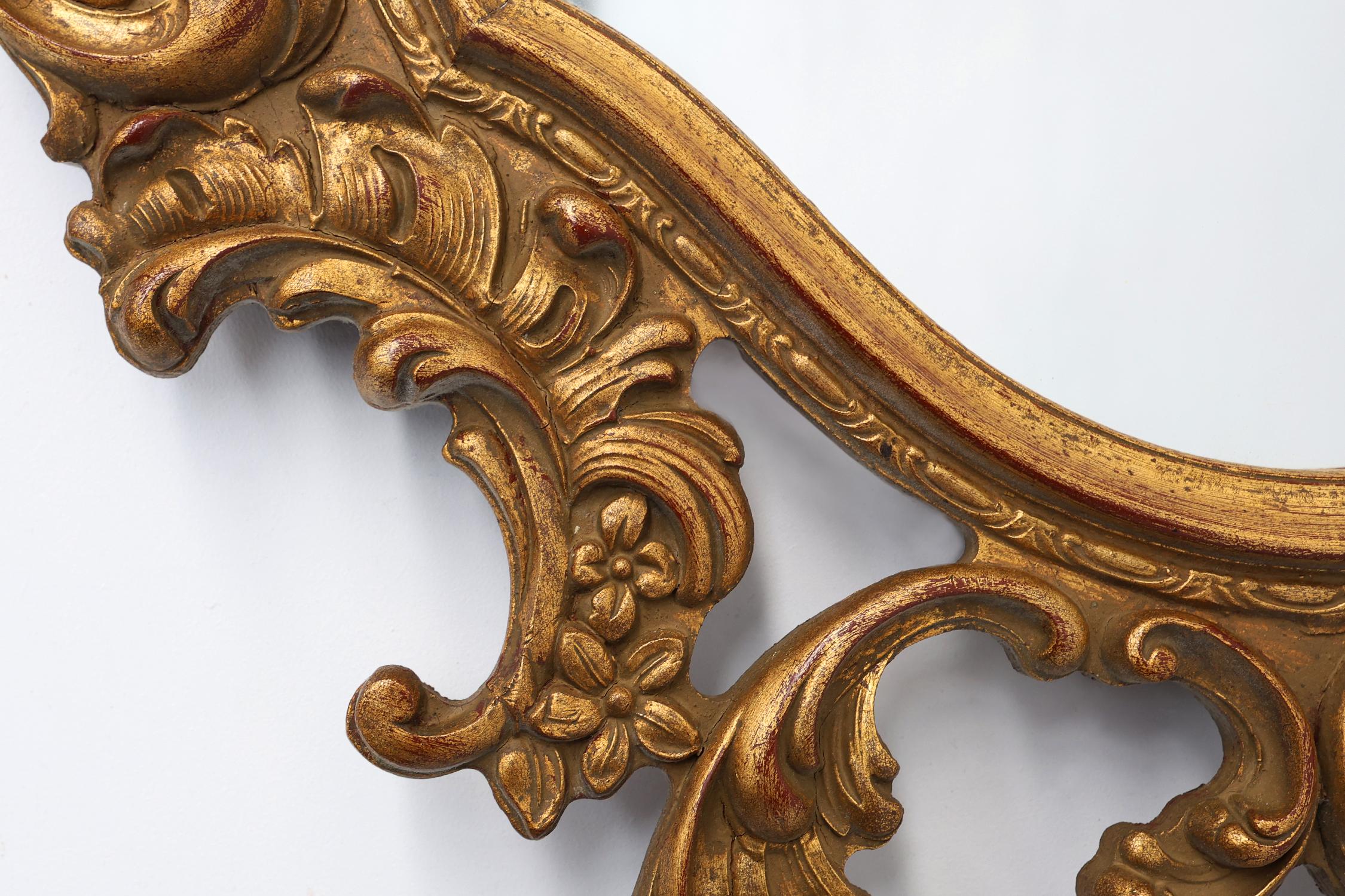 French Baroque style oval wall mirror in gilded wood, France For Sale