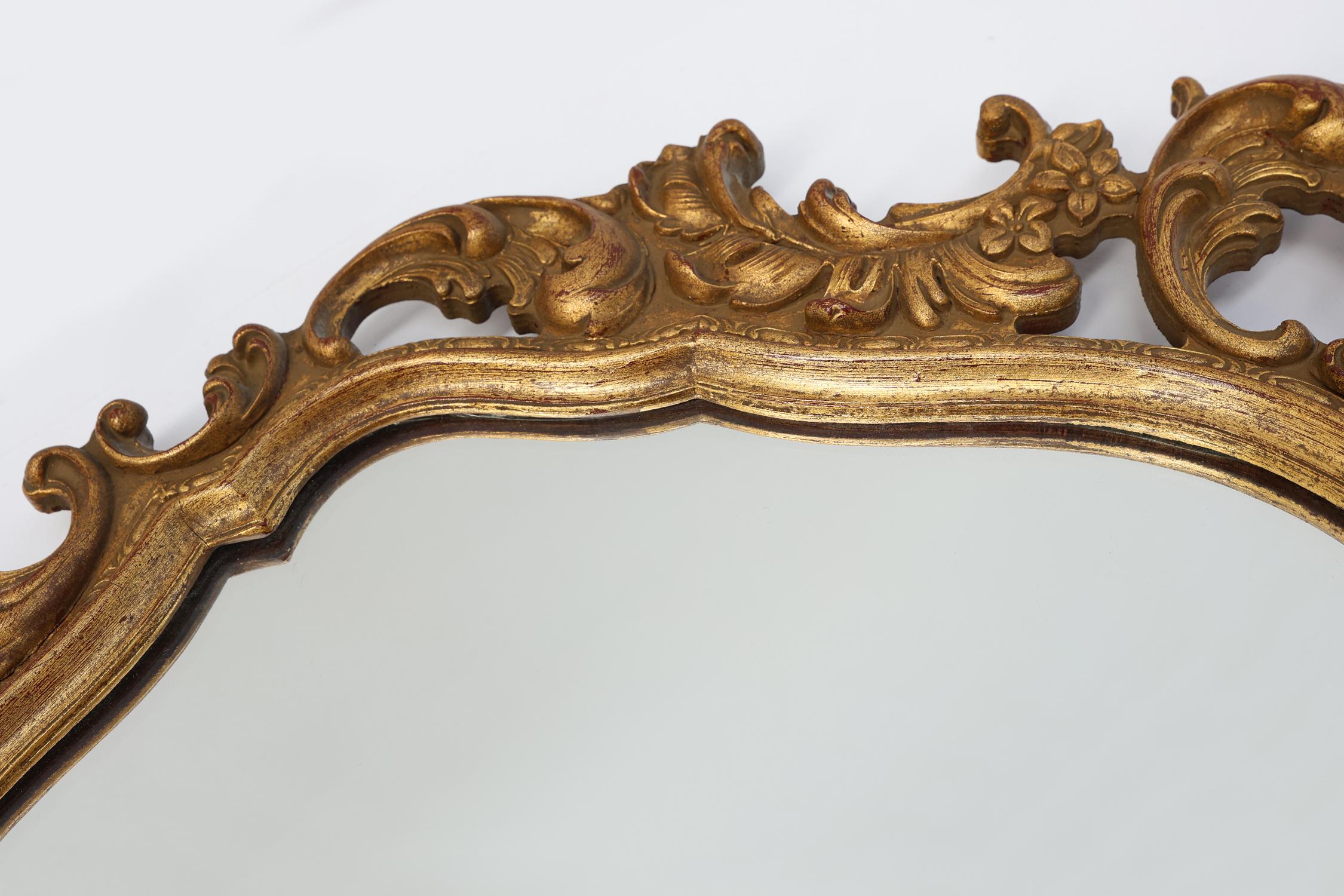 Mid-20th Century Baroque style oval wall mirror in gilded wood, France For Sale