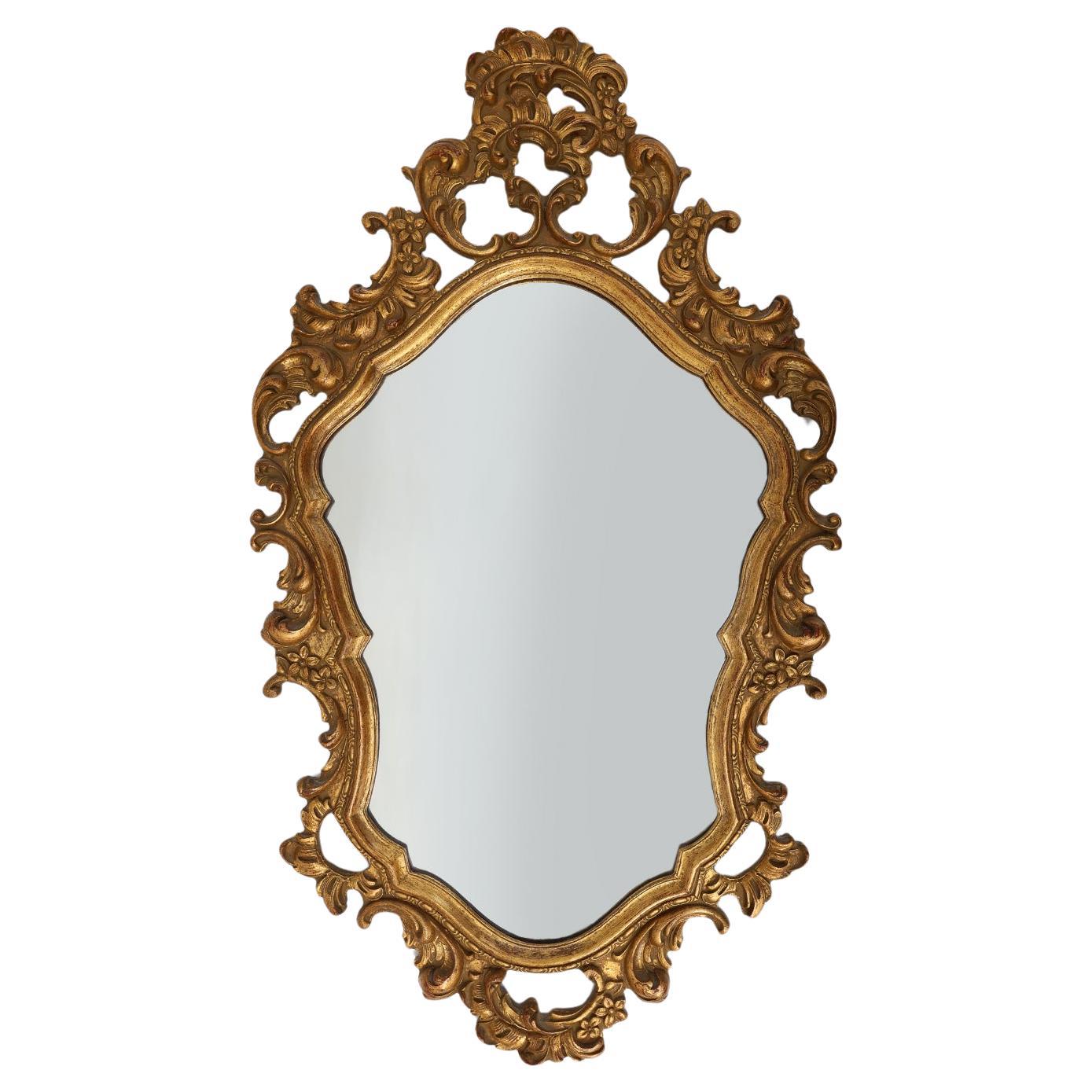 Baroque style oval wall mirror in gilded wood, France For Sale