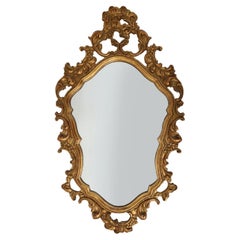 Baroque style oval wall mirror in gilded wood, France