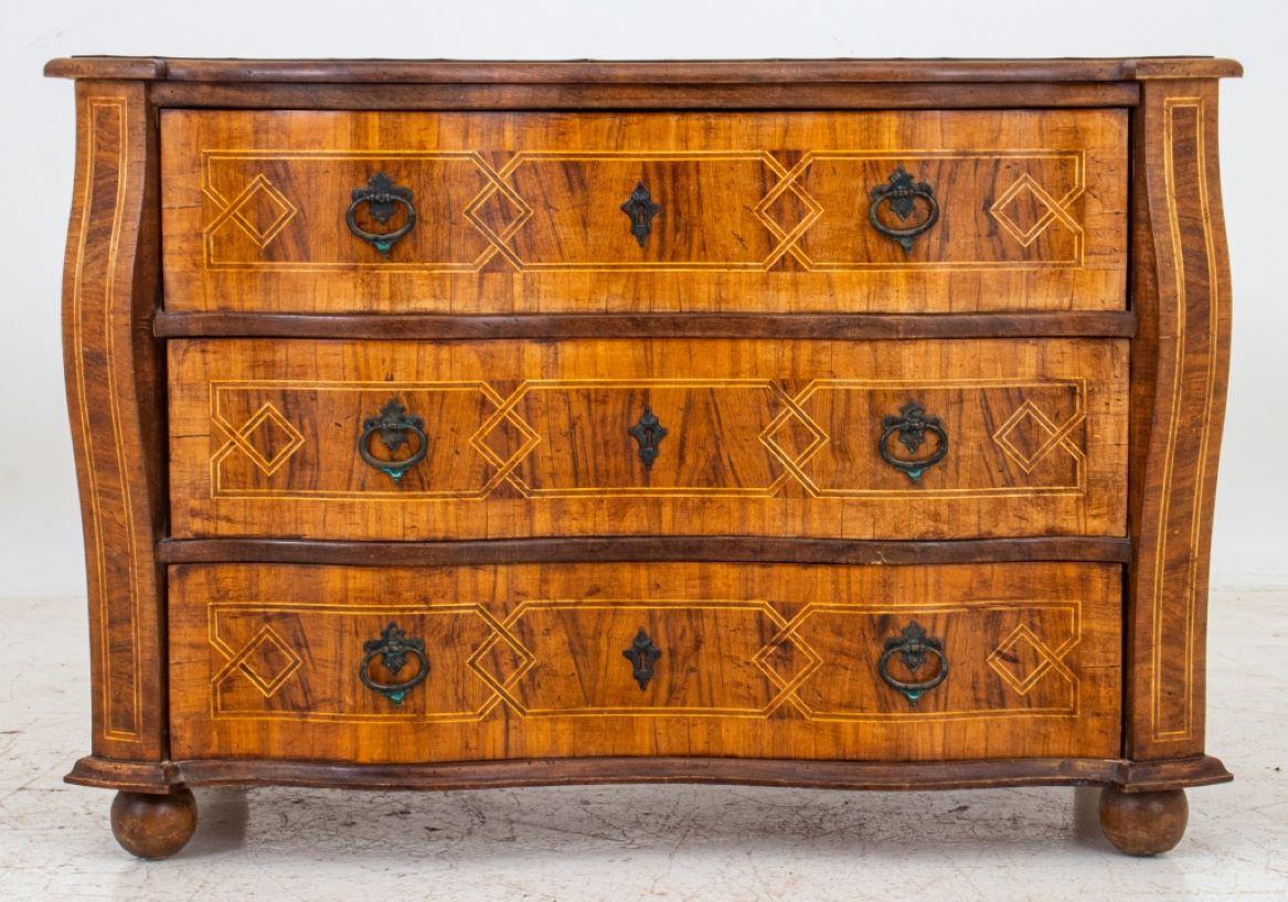 Baroque Style Parquetry Three Drawer Chest in the Italian style, with shaped rectangular top and serpentine front with chamfered corners, the chest all over inlaid with geometric parquetry stringing patterns,three long drawers with patinated metal