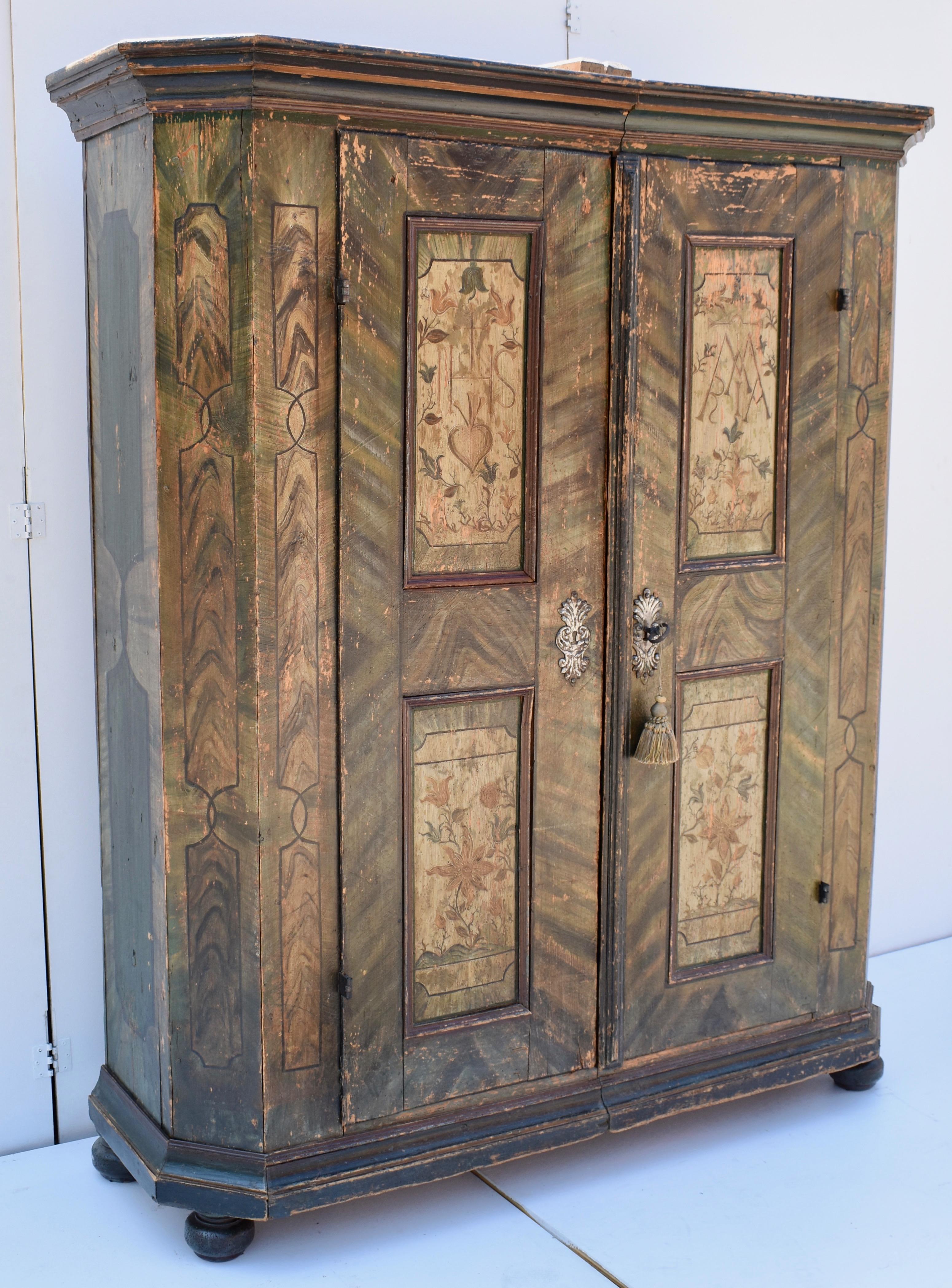 This extraordinary Baroque style armoire is one of the nicest we have ever had. It has spent the last thirty years in this dealer’s home. Downsizing now necessitates its sale.
Beneath the beautiful contours of the bold crown molding are two doors,