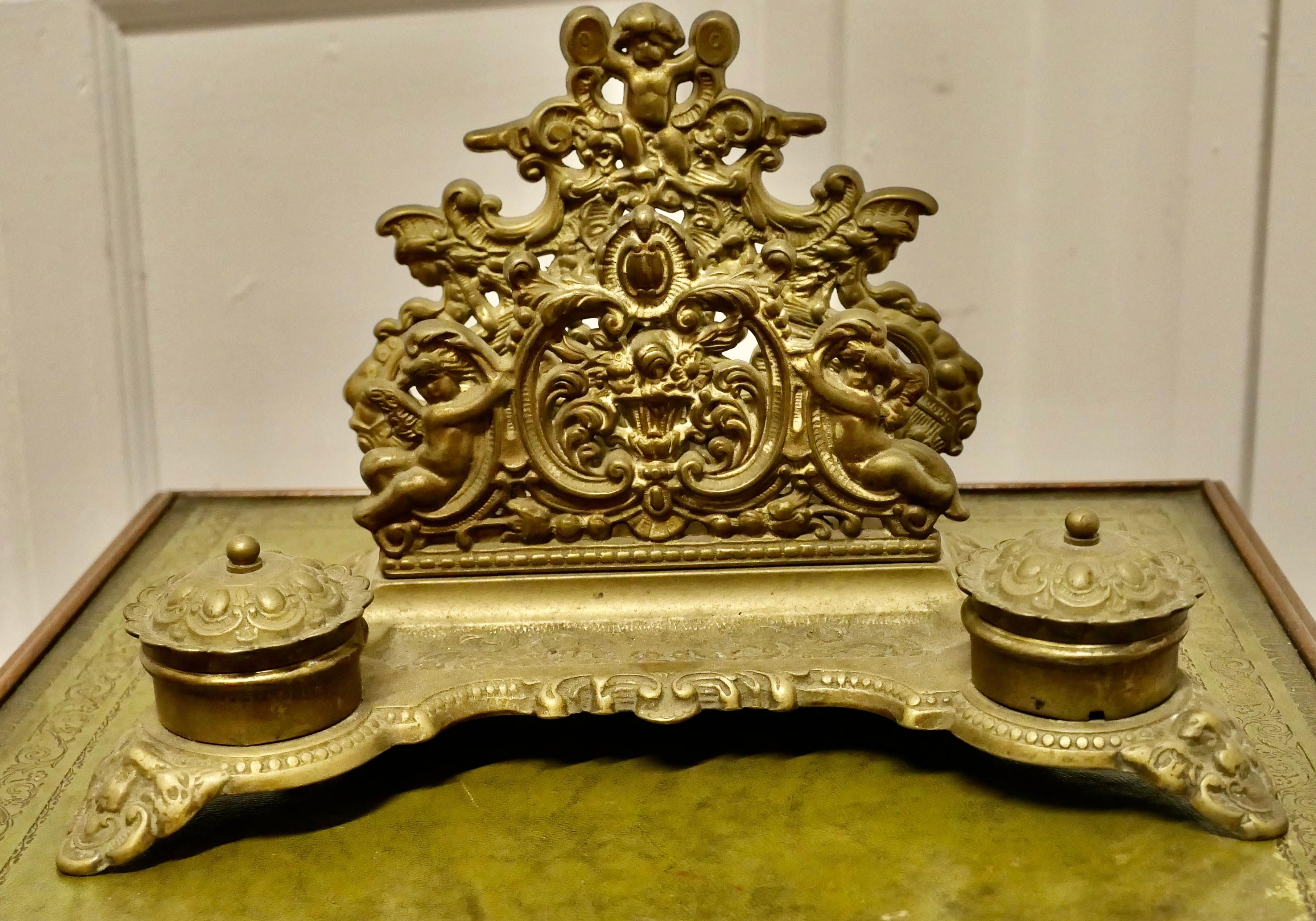 Baroque Style Putti Letter Rack with 2 Inkwells

This is a very grand desk top inkwell, the letter sections are decorated with Putti and Cherubs there is  a pen rest and on each side a lided ink pot

A Lovely piece, the stand is 8” high, 11” wide