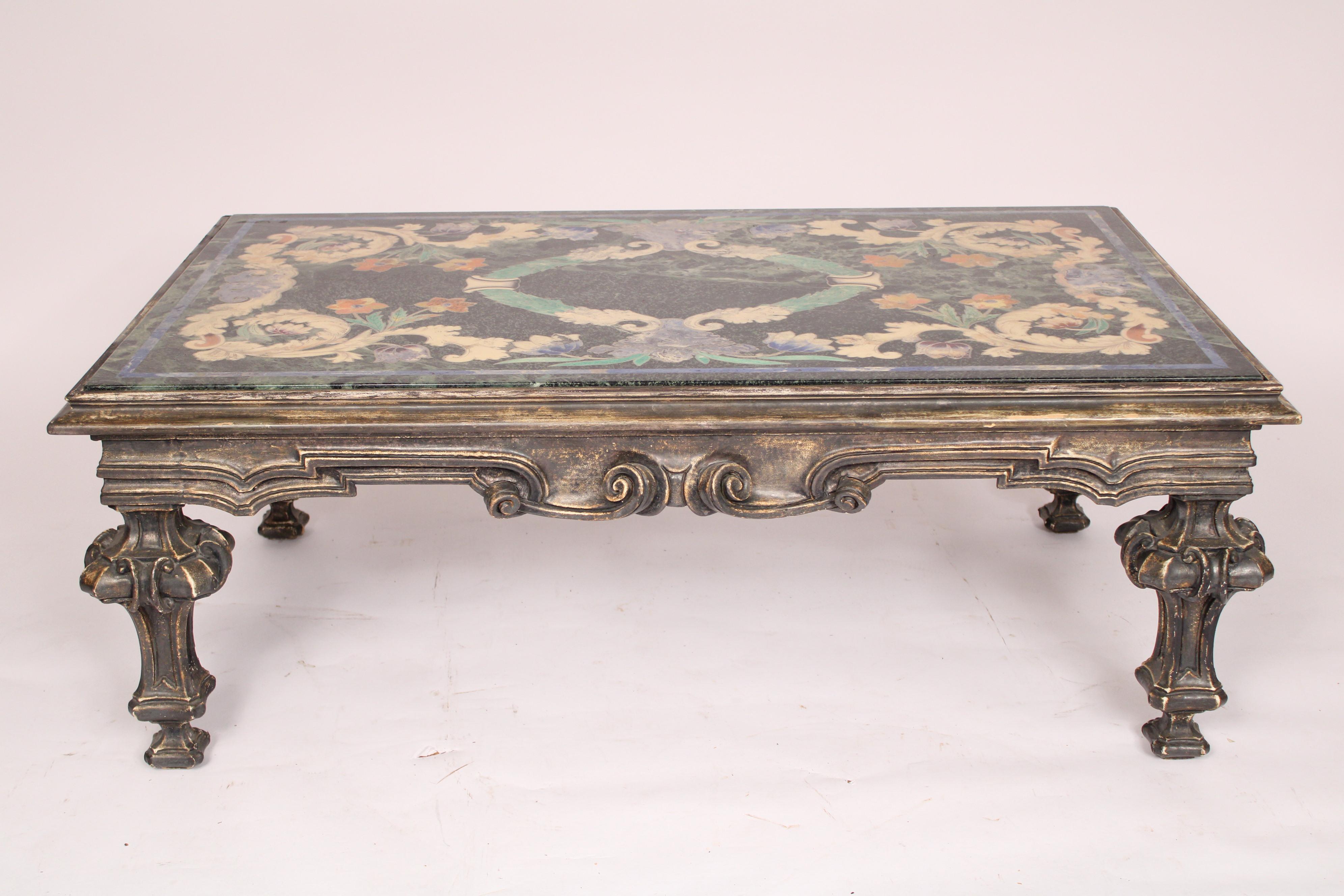 Baroque style scagliola decorated marble top coffee table, mid 20th century. With a scagliola marble top, inset into a wood carved silver leaf baroque style coffee table frame. Made in Italy, circa mid 20th century. Professional restoration to