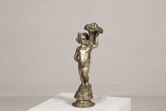 Baroque Style Silvered Bronze Statuette of a Putto Carrying a Fruit Basket