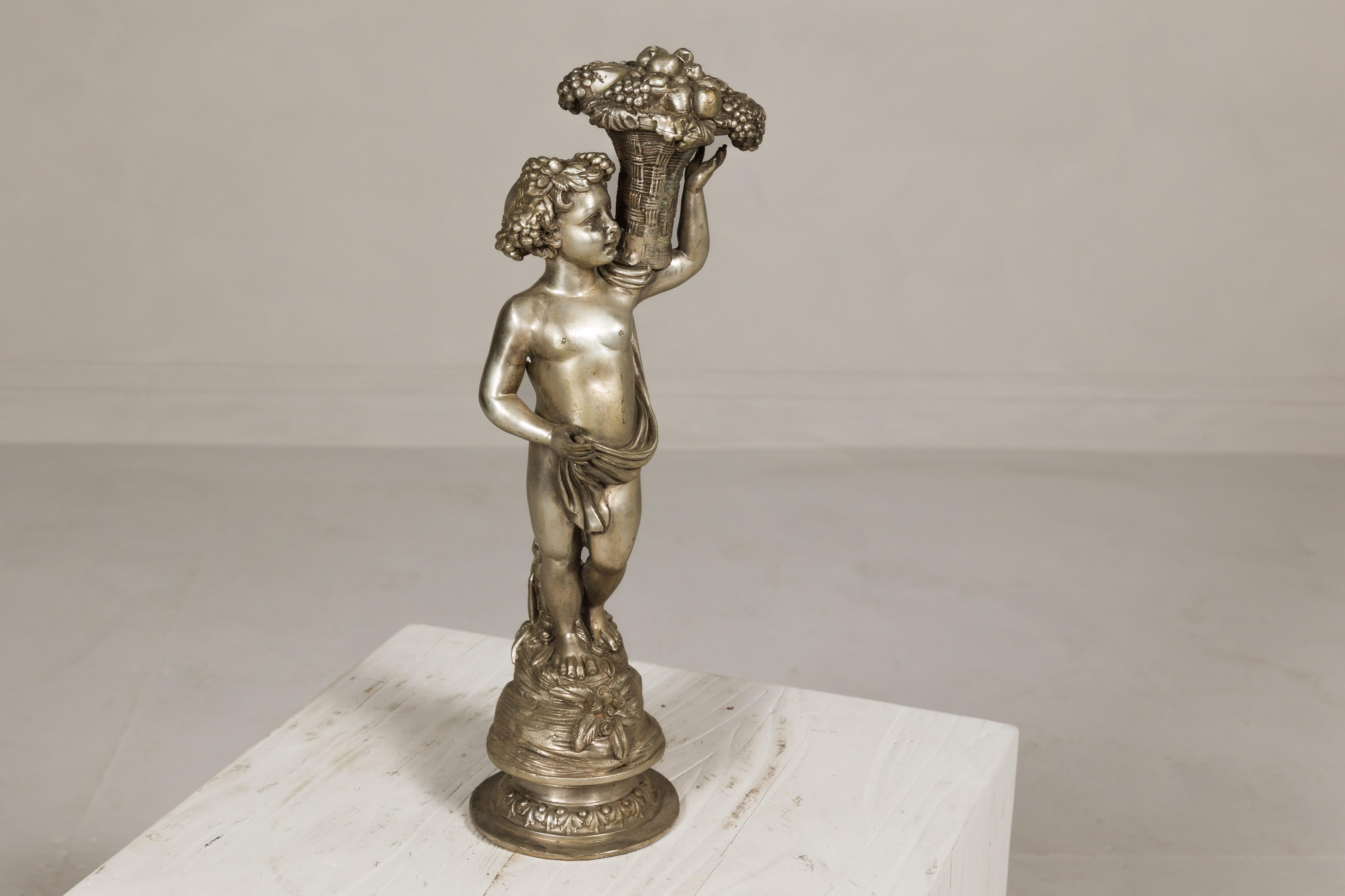 Baroque Style Silvered Bronze Statuette of a Putto Carrying a Fruit Basket In Good Condition For Sale In Yonkers, NY