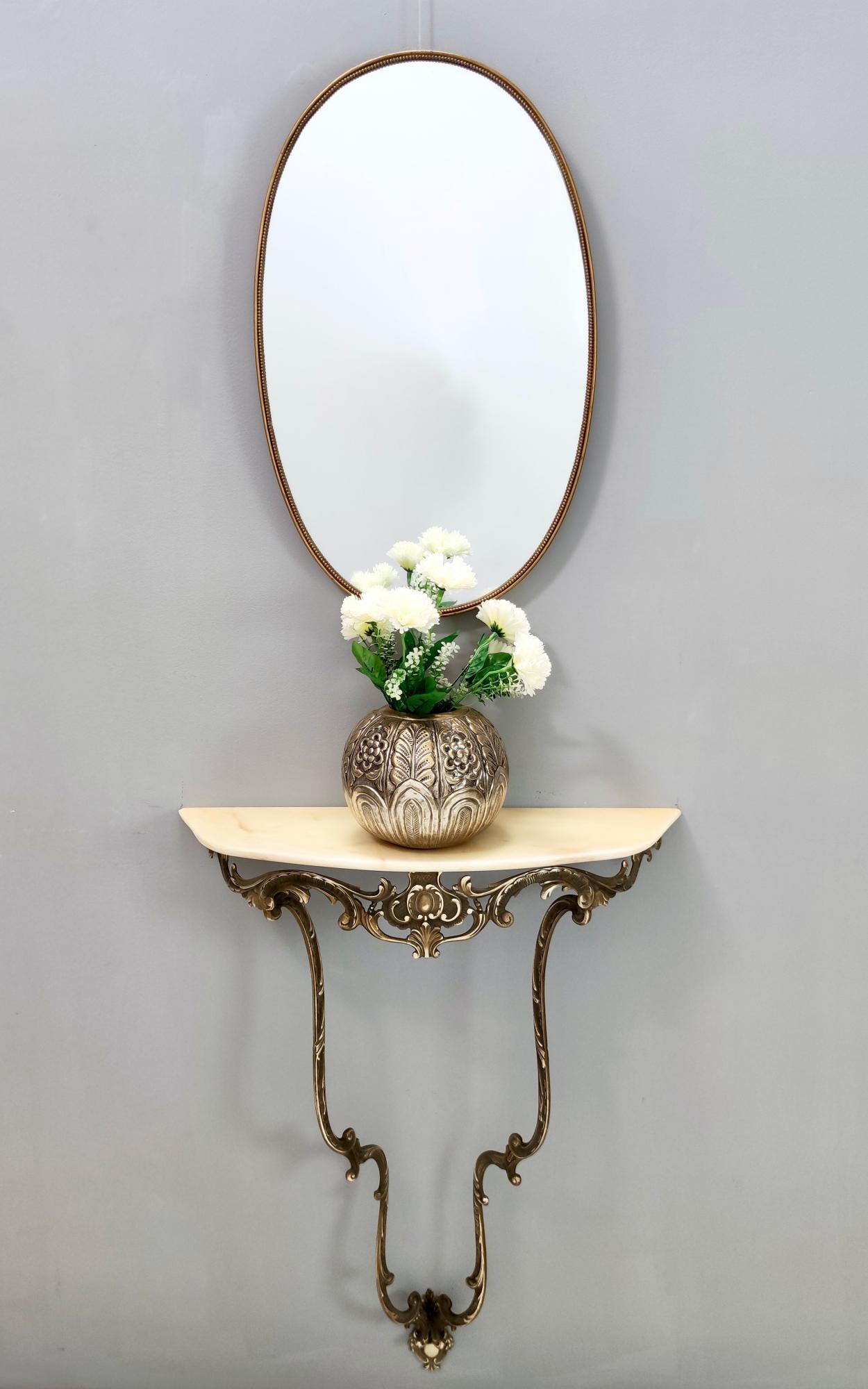 Made in Italy, 1960s. 
It features a brass frame and a demilune Portuguese pink marble top. 
It might show slight traces of use since it's vintage, but it can be considered as in excellent original condition and ready to become a piece in a