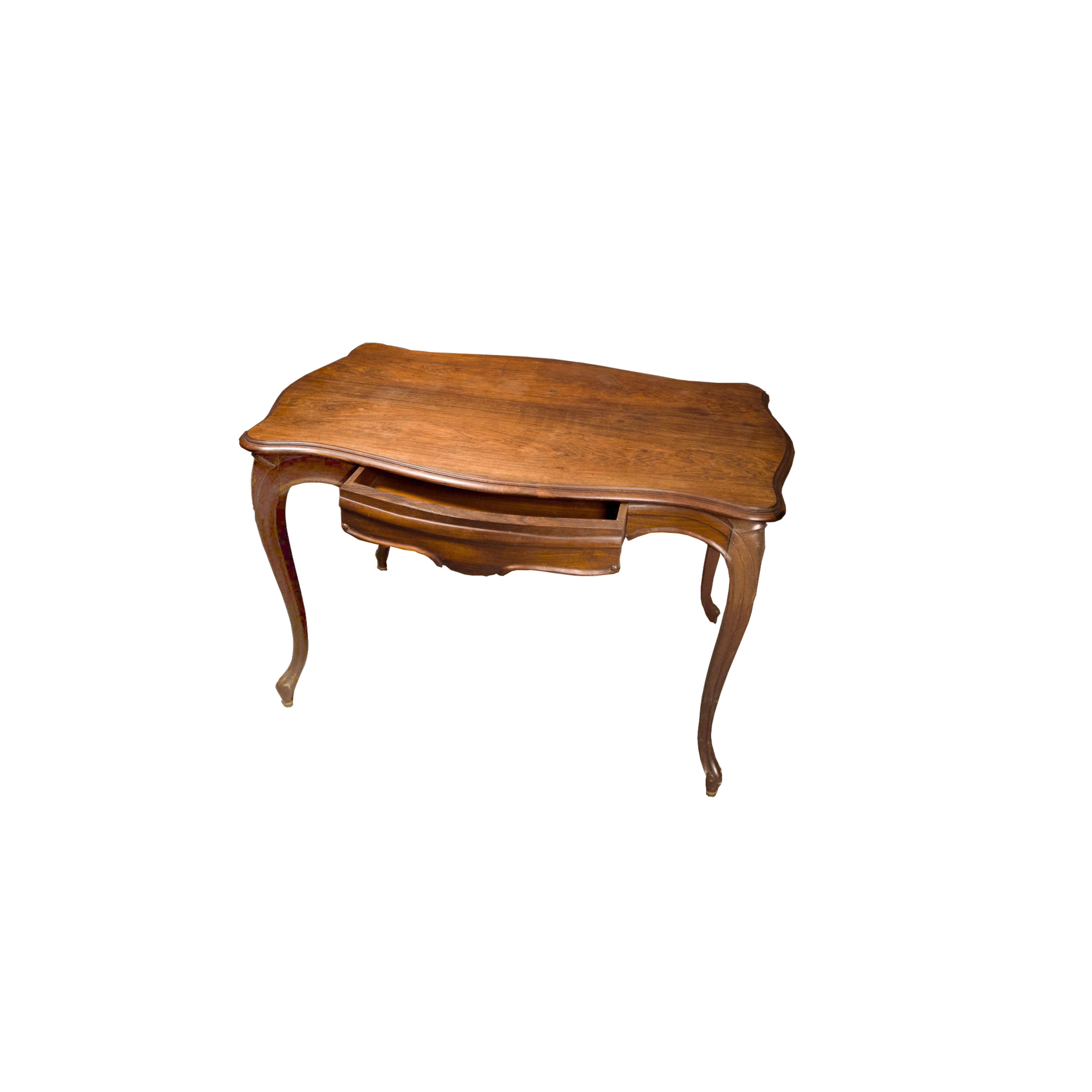 A baroque style walnut writing table with a serpentine rectangular top, rounded frieze, deeply sculpted cabriole legs, pipe legs and wide drawer.Comfort and order. An exemplar of elegance.