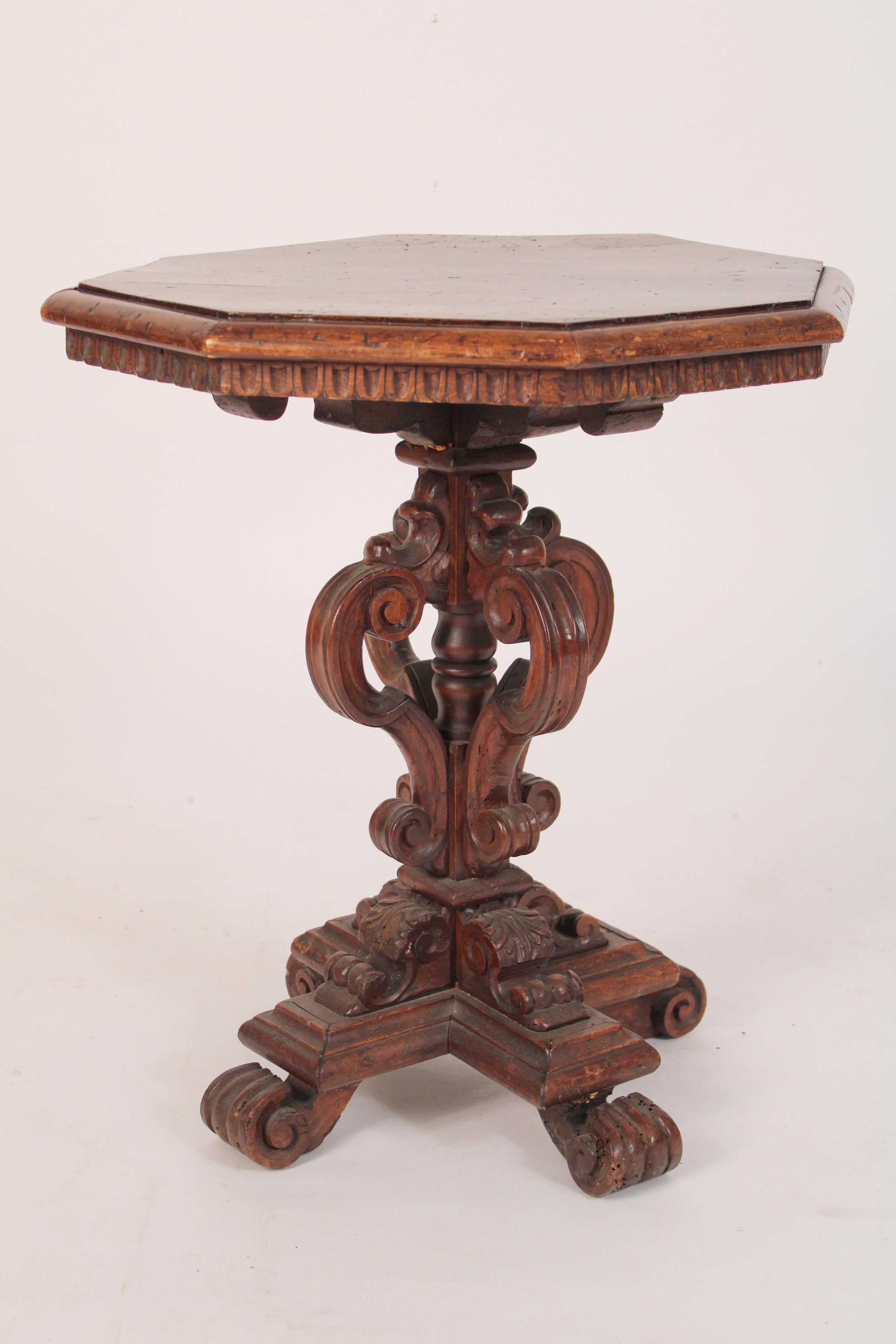 Italian baroque style walnut occasional table, made from antique and later elements, assembled circa 1920's. With an octagonal top with molded borders, S scroll pedestal supports resting on a 4 prong base, with scroll feet.