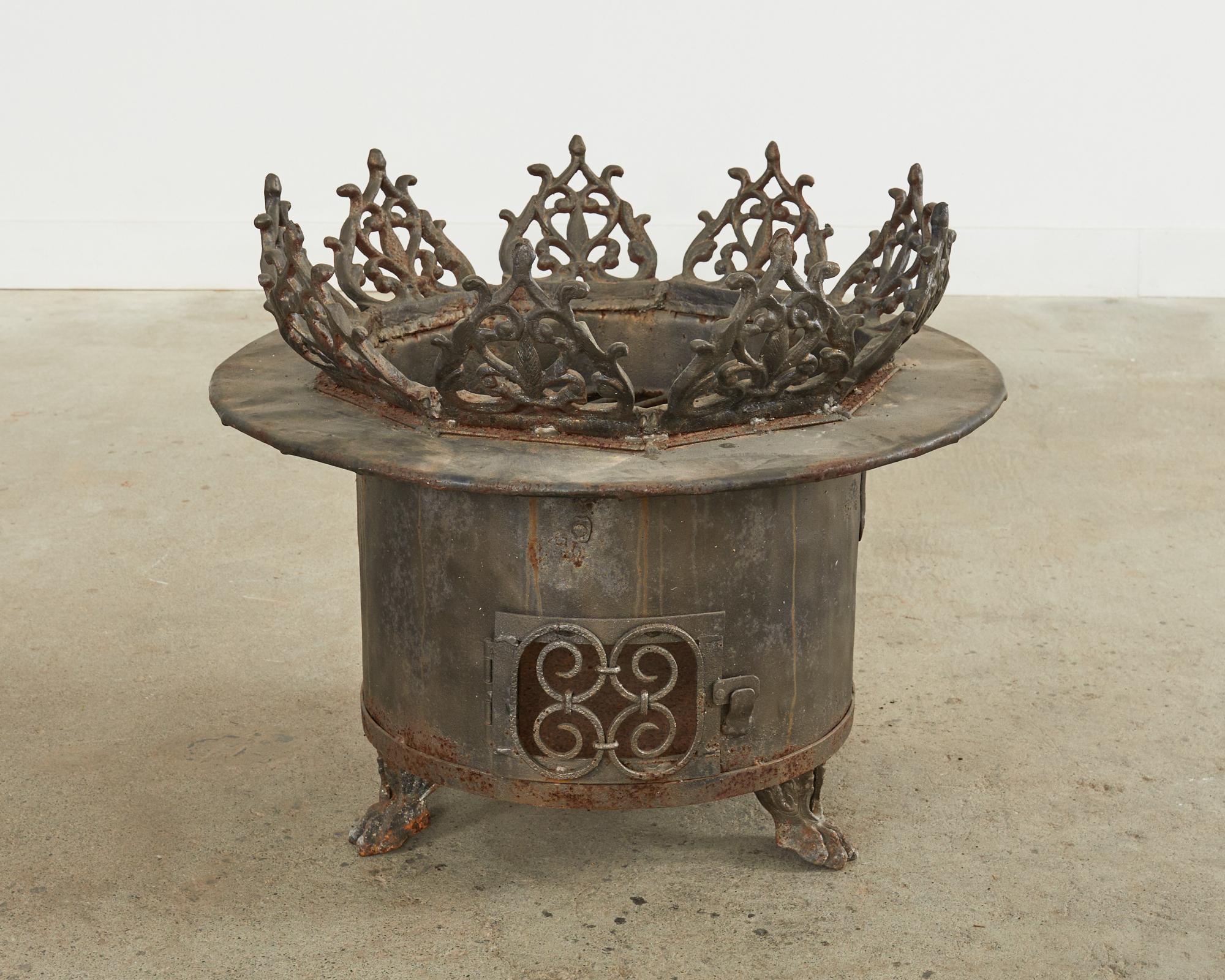 Fantastic custom made wrought iron brazier fire pit or chimnea. The round pit features a decorative border on top of scrolled acanthus appearing like flames. The pit is supported by baroque style lions paw feet. The open top measures 18 inches