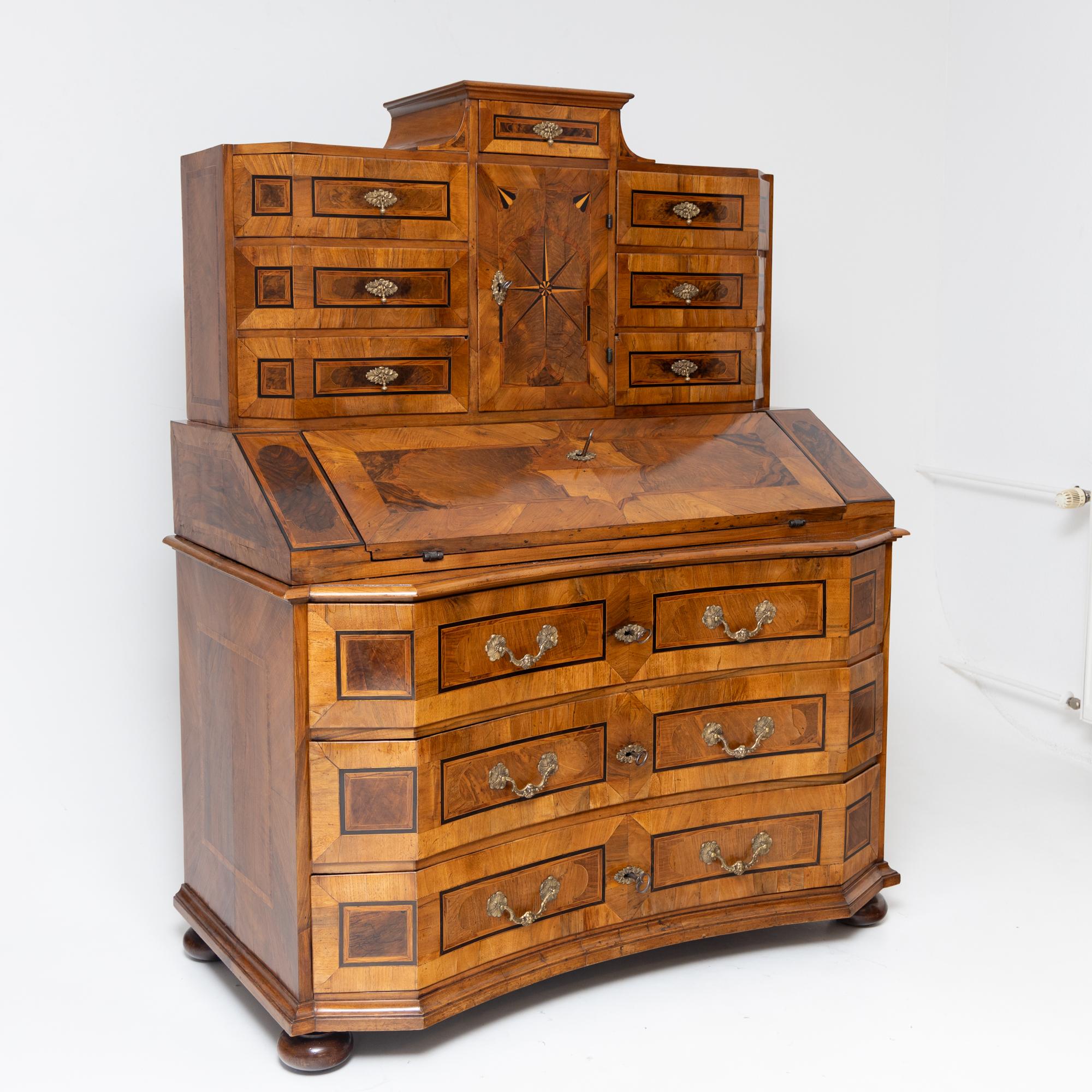 Baroque Tabernacle Secretaire in three parts, boasting a three-drawer lower chest set on graceful compressed ball feet. The gently curved drawer fronts offer comfortable seating. Above, a slanted flap with a central lock reveals four compartments