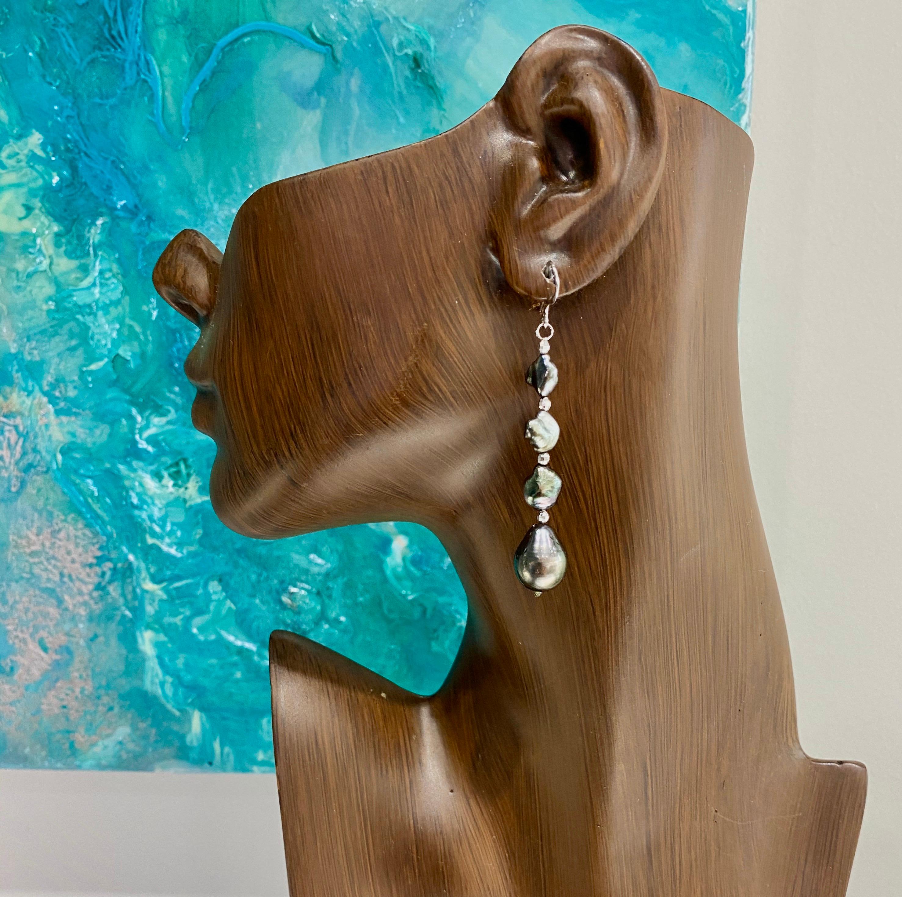 These stunning earrings are made of Tahitian drop shaped pearls, 12mm and Tahitian Keishi pearls, naturally colored with beautiful luster.  They dangle from a sterling silver hook and have diamond cut sterling silver accent beads for some sparkle. 
