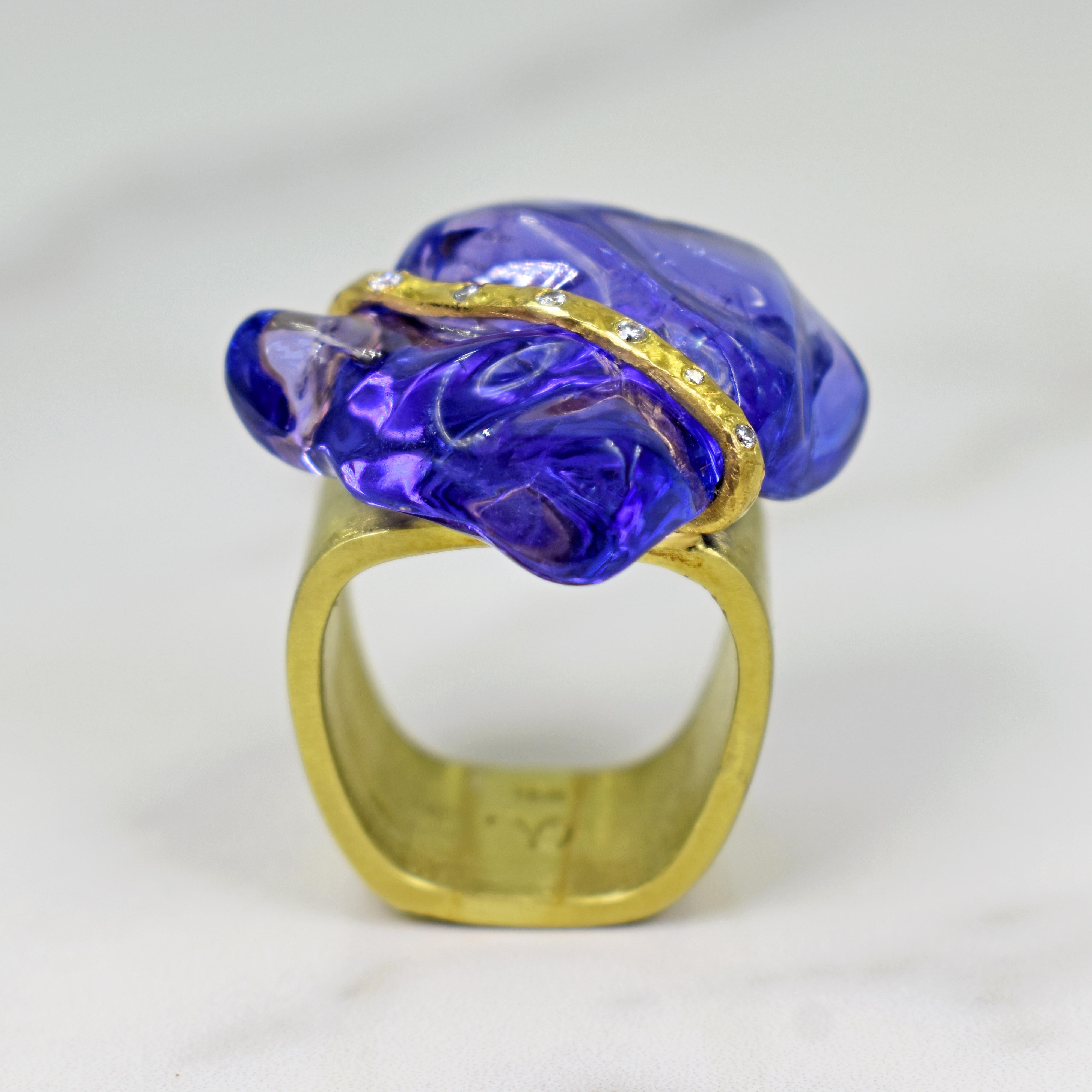 Rough, polished “Baroque” Tanzanite gemstone set with a Diamond and 22k yellow gold ribbon on an 18k gold square-shaped cocktail ring. Size 7. Unique and one-of-a-kind artisan statement ring featuring a magnificent bluish-purple Tanzanite. 
