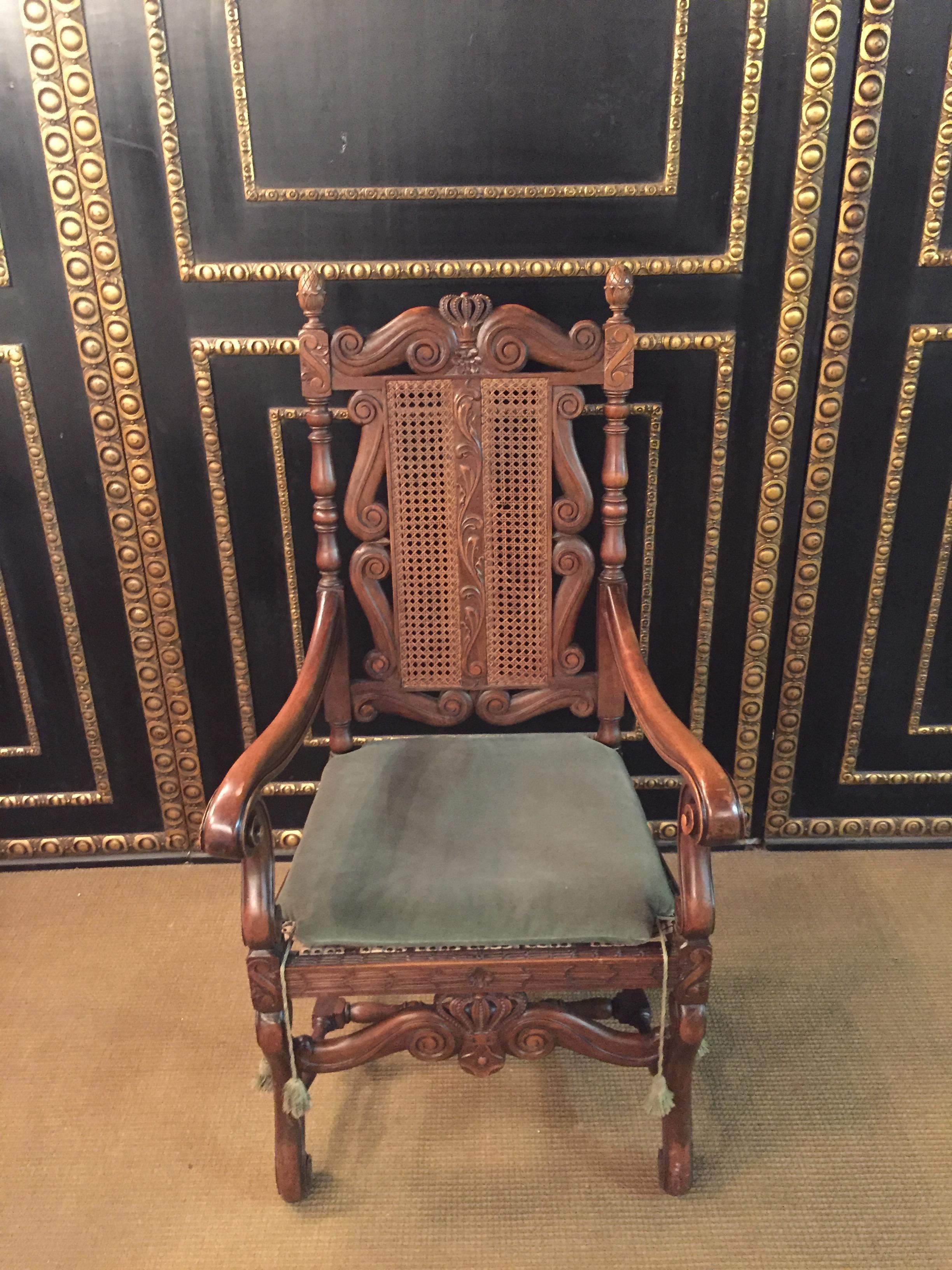 Beautiful armchair fully carved solid walnut,
on the backrest with wickerwork
right and left carved pillars
in the middle of the chair a carved crown.
swing armrests.
Feet are connected by pillars.
Down in the middle is also a carved crown.