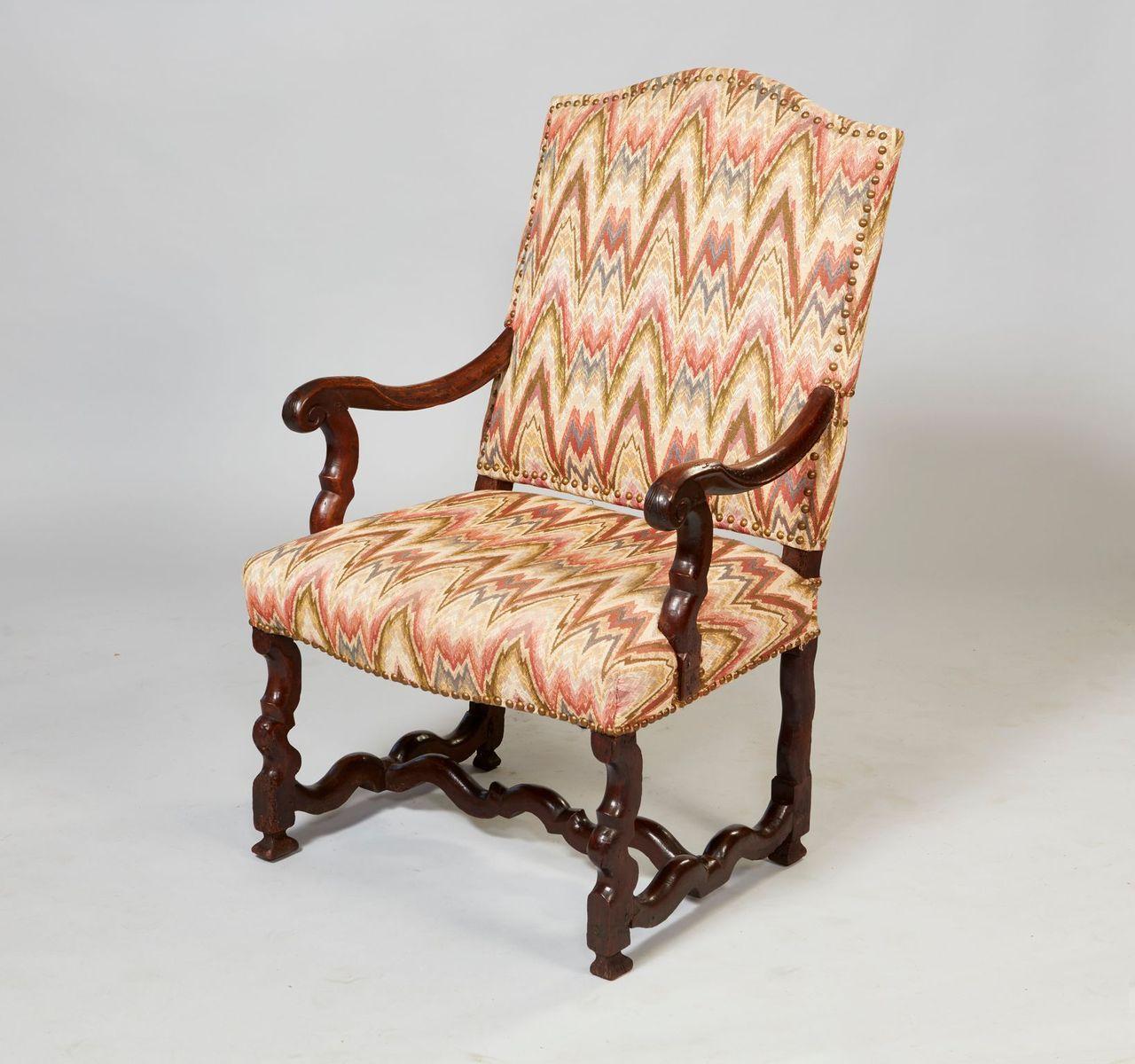 Good early 18th Century Franco-Flemish walnut armchair with arched upholstered back over shaped arms and upholstered seat over