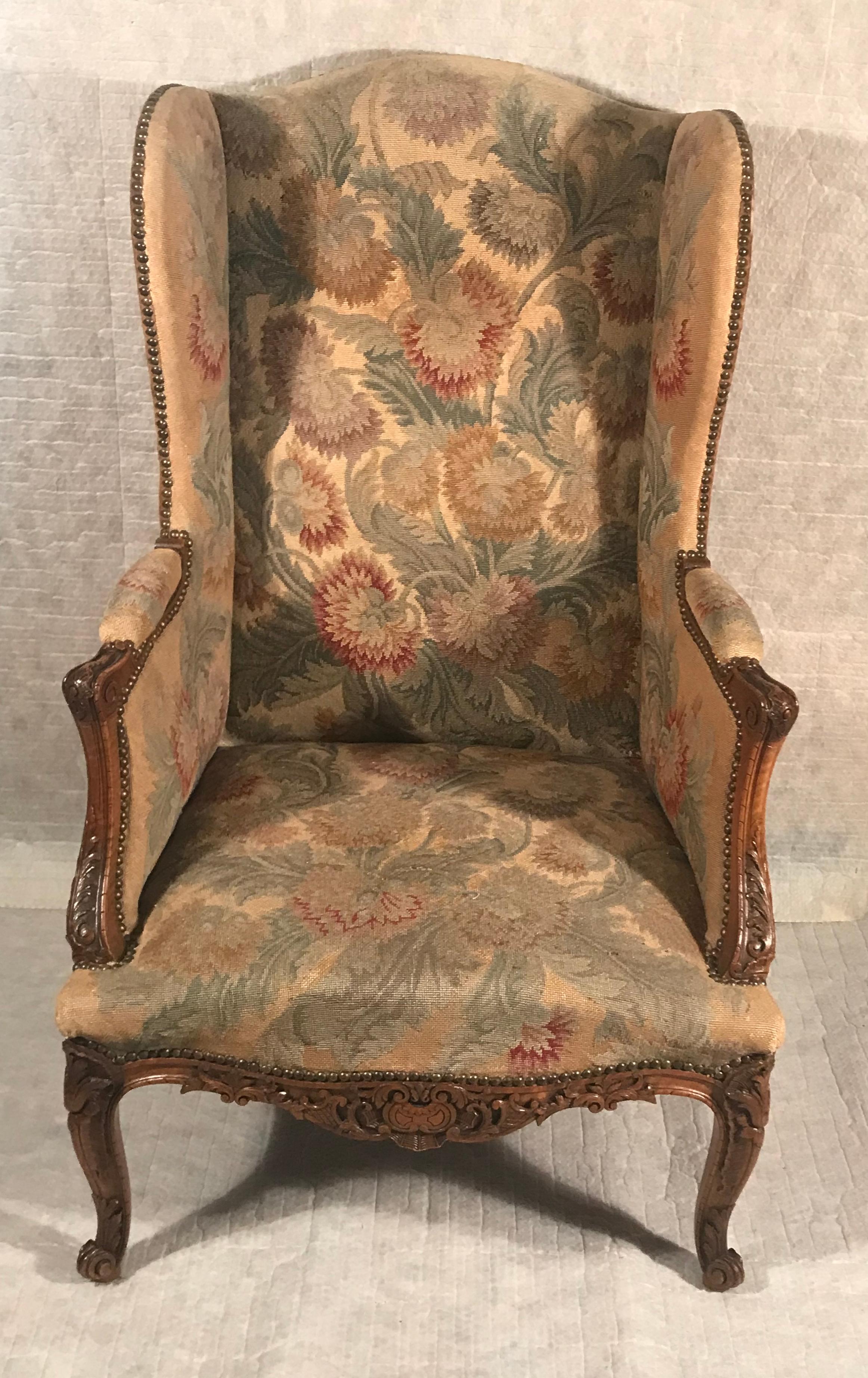 Introducing an exquisite Baroque wingback armchair that transports you back to the elegance of the 18th century. This remarkable piece, originating from Germany around 1760, showcases the grandeur and craftsmanship of the Baroque era.  Crafted with