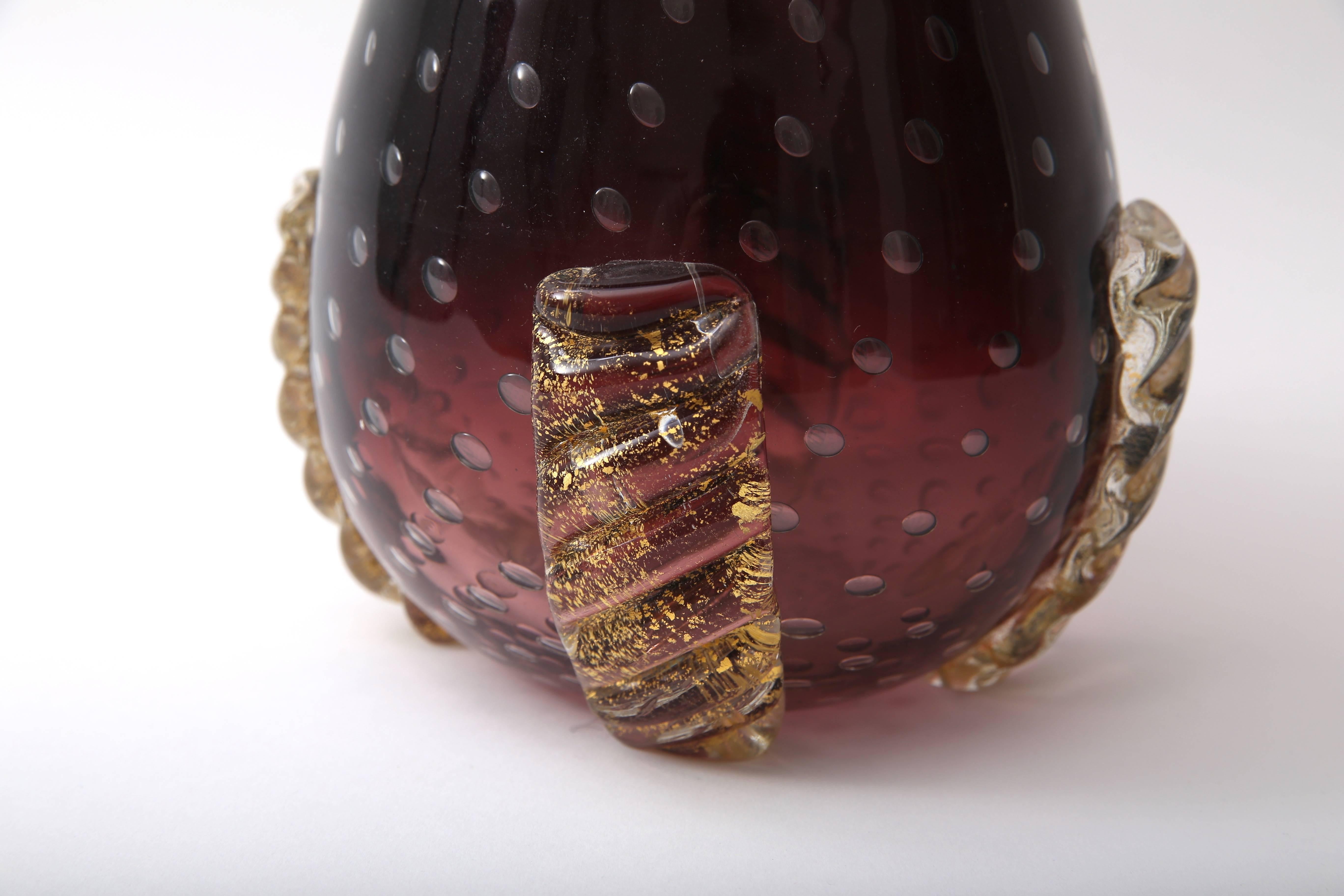 This stylish and rare piece of Murano glass was created by the iconic glass makers Barovier et Toso and will make a perfect addition to your collection or for everyday use with a floral arrangement. The aubergine and gold coloration compliment