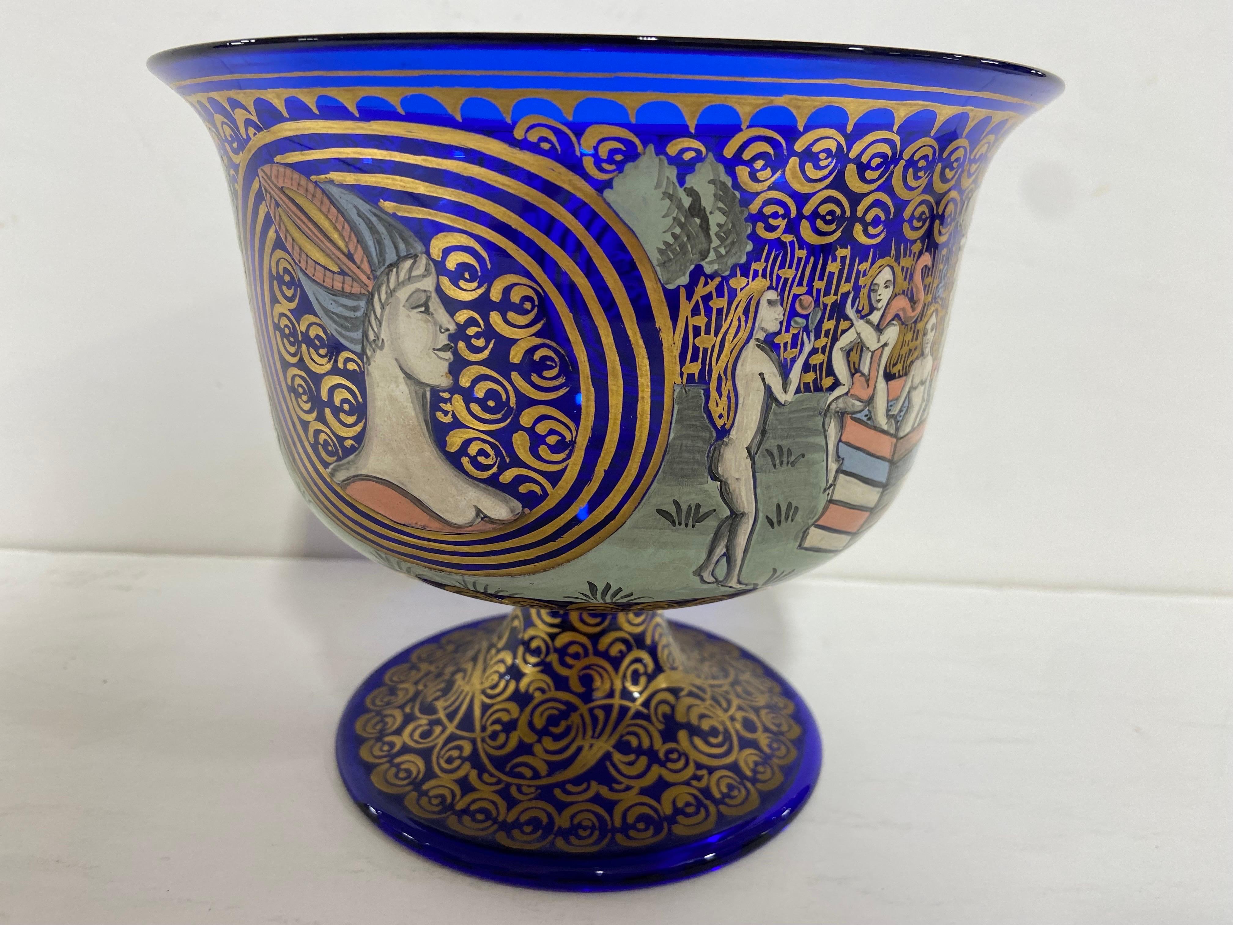A Barovier and Toso design from Murano Italy. An Italian wedding cup dating to the mid 20th century created in cobalt blue glass with hand painted and gilt decoration. The bell shaped top is painted and decorated with Renaissance inspired painted